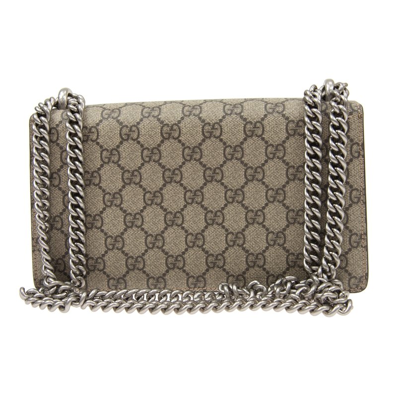 Gucci Dionysus small shoulder bag: The small Dionysus shoulder bag is presented in the signature GG pattern, trimmed with taupe suede details. The shape is defined by the defining tiger head closure—a unique detail referencing the Gr