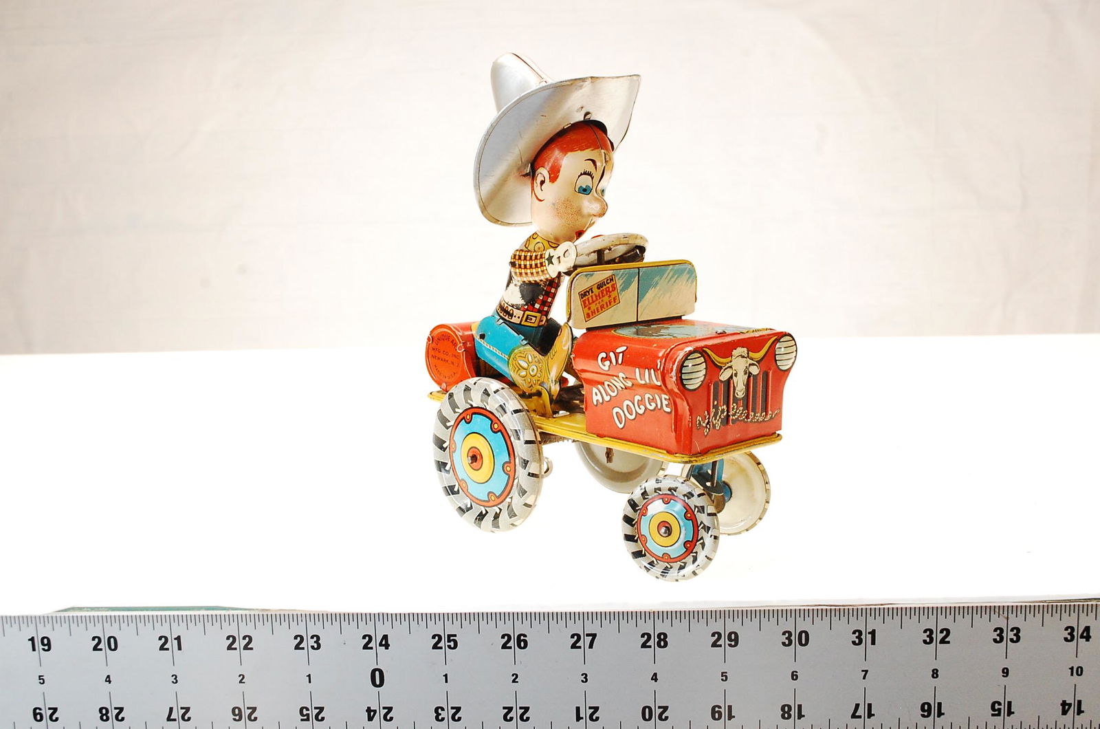 VINTAGE UNIQUE ART RODEO JOE TIN WIND UP TOY COWBOY: Rodeo Joe Tin Wind Up Toy Cowboy Presented for auction is a wonderful Rodeo Joe Crazy Car, made by the Unique Art Mfg. Company. Crazy Car moves forwards, backwards, and tips up. Item in very good cond