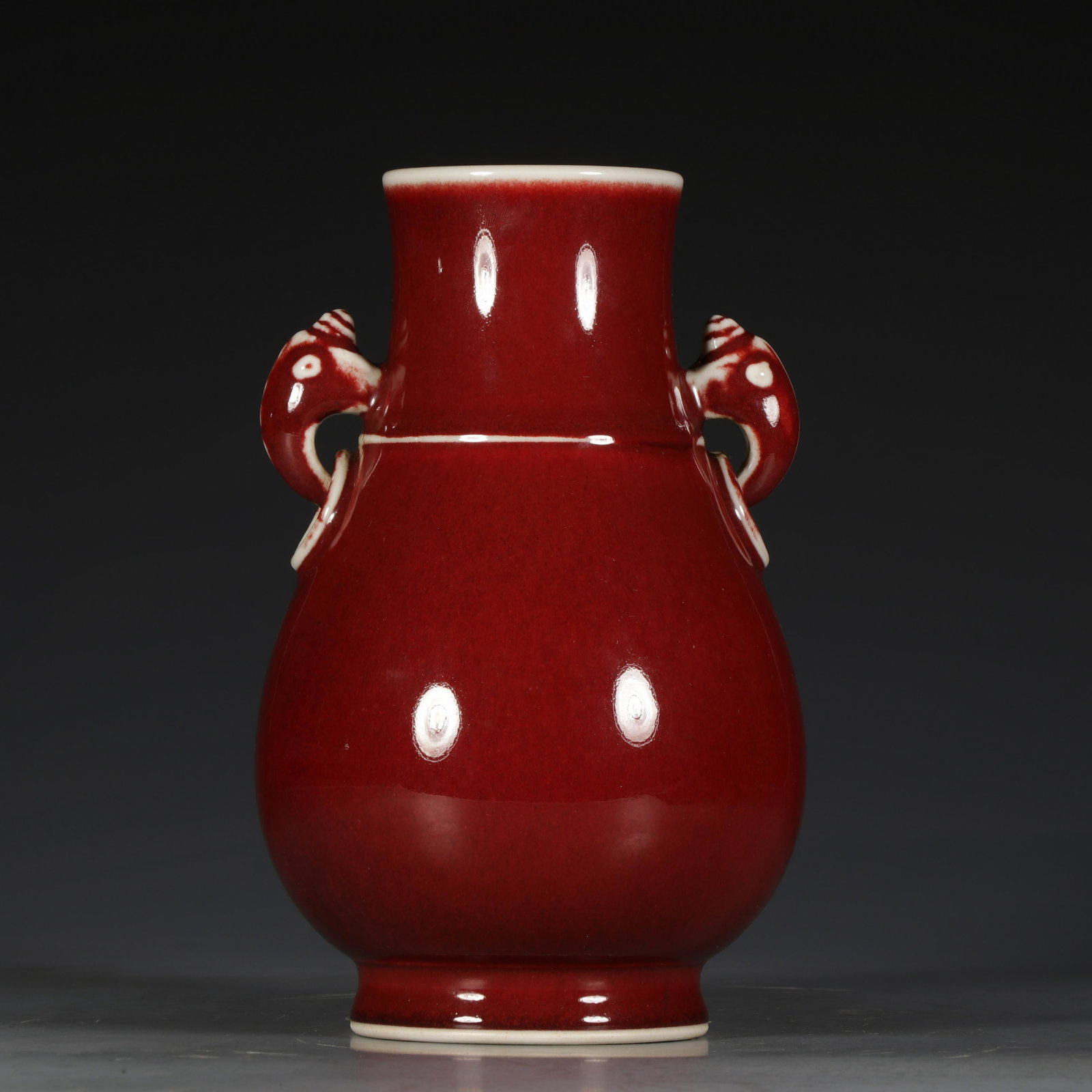 A Chinese Sang-de-boeuf vase, paired with elephant-head: A Chinese Sang-de-boeuf vase, paired with elephant-head handles, with a Yongzheng, H 21,5 cm