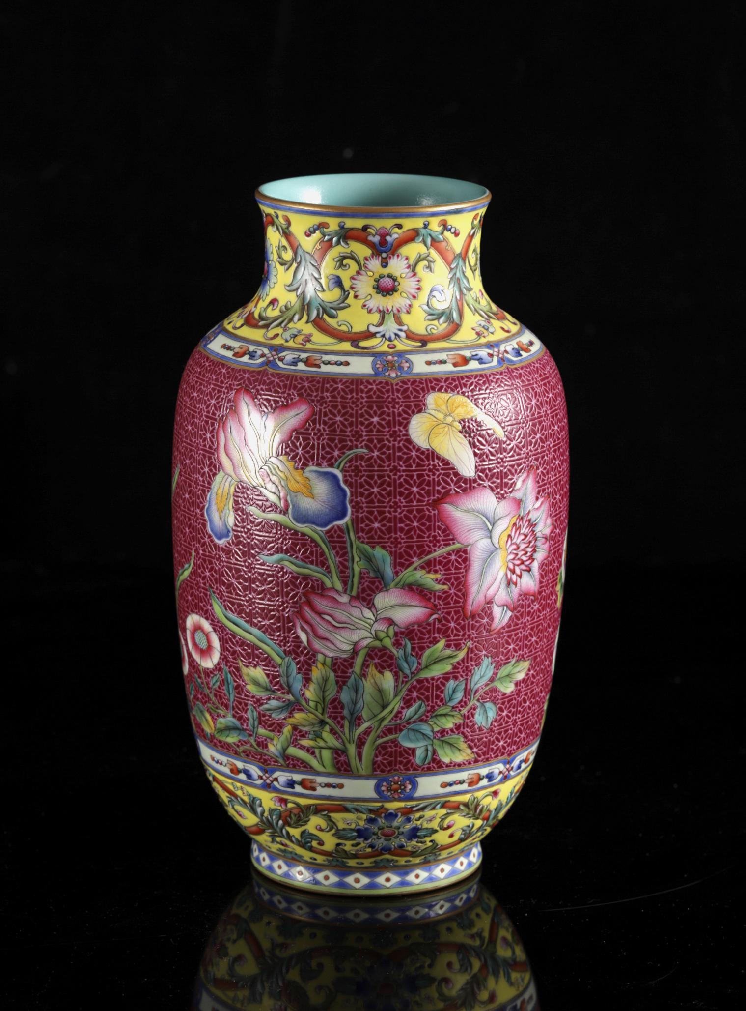 A Chinese famille rose ruby ground sgraffito 'Butterflies and flower' vase, Qianlong mark, H 26 cm (1 of 6)