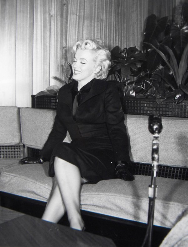 Marilyn Monroe, press photo for "Prince and the Show: Marilyn Monroe, photograph of press conference for "Prince and the Showgirl" (with man on couch), 1957, 8 x 10, Facts: (1926–1962) American actress, model, singer and sex symbol. Her first film cont
