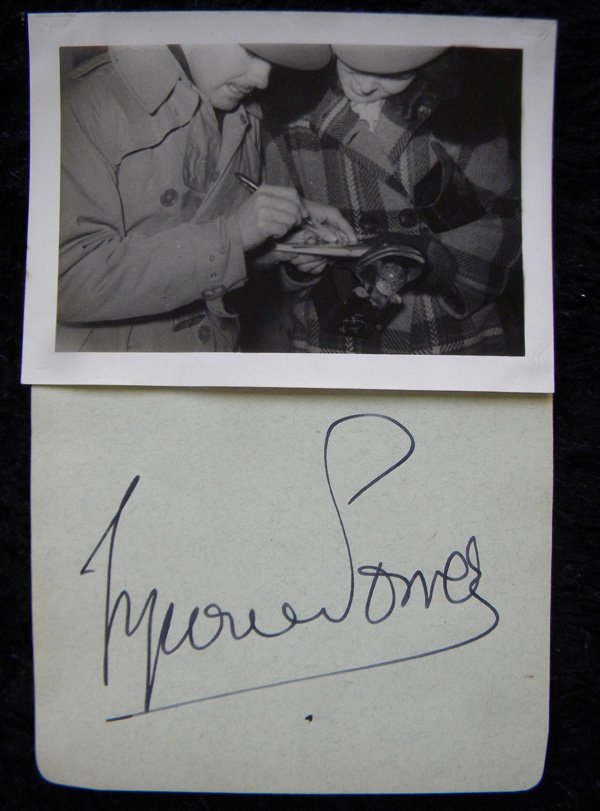 Tyrone Power, 5x7, signed album page with photo of: Tyrone Power, 5x7, signed album page with photo of him signing it, 40’s, Annabella (born Suzanne Georgette Charpentier on April 23, 1939) signature on 3 x 5, Facts: Tyrone Power (1913-1958) American