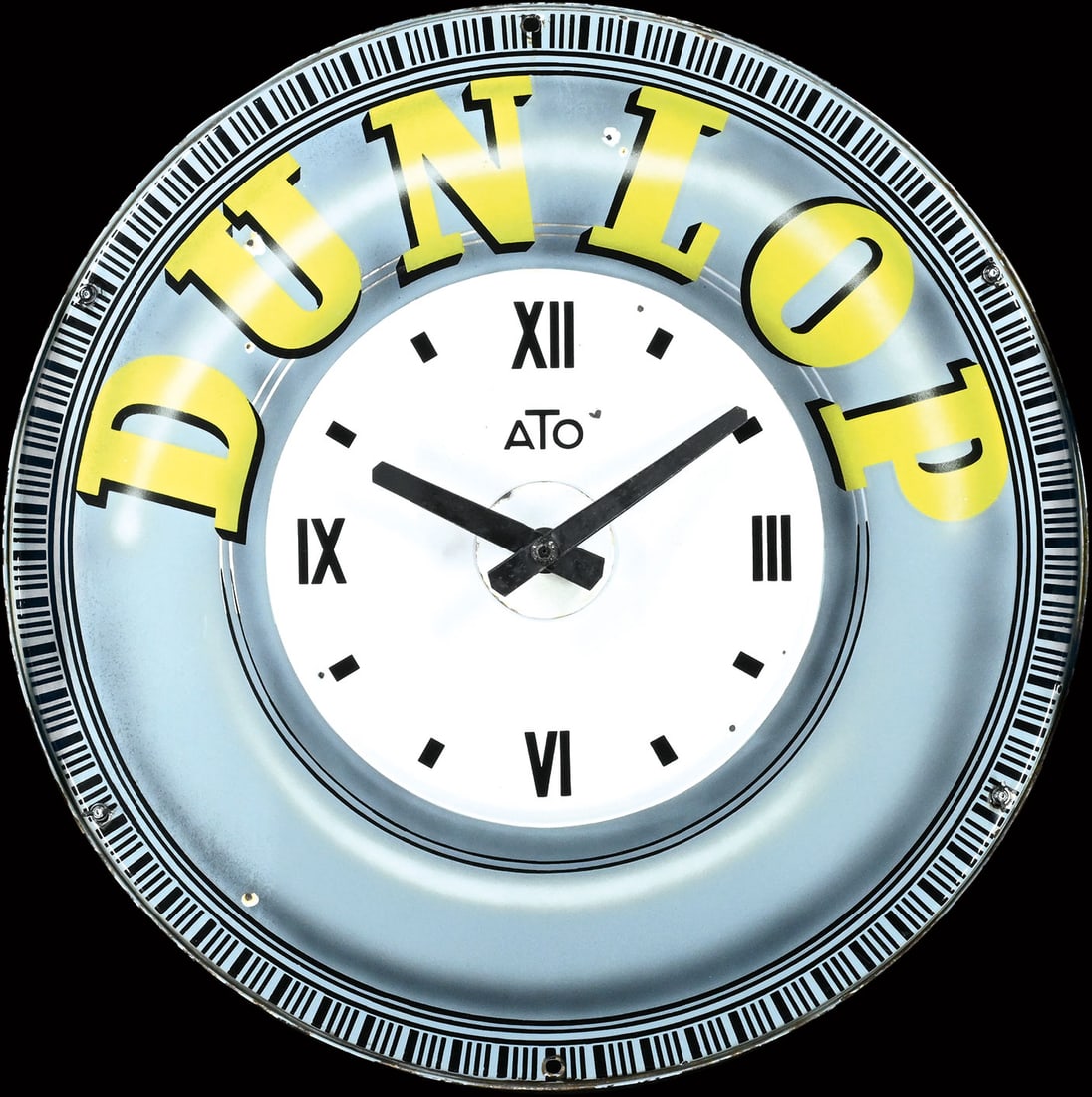 DUNLOP | 39" PORCELAIN SIGN WITH CLOCK: Porcelain sign ( Enamel sign ), the material partly embossed in relief, stenciled and lithographed, around 1950, diam. 100 cm, an impressive piece with practical everyday use, still featuring the orig