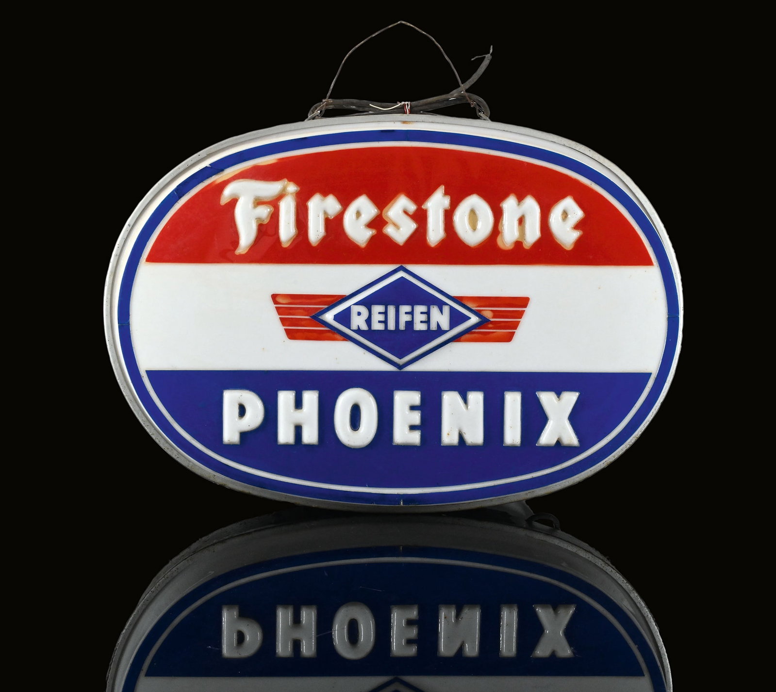 PHOENIX FIRESTONE | 28" LIGHTED SIGN: Old neon, plastic, embossed in relief, tin body, 1950s, 72 x 50 cm, in nice original condition, slight signs of age and usage, the electrical system appears to be complete, but the wiring needs to be 