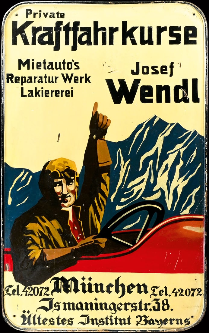 KRAFTFAHRKURSE JOSEF WENDL | UNIQUE 39" TIN SIGN: Tin sign, colored by hand, GER around 1920, 62 x 100 cm, an antique advertising sign for a Munich-based auto repair shop. Against an Alpine backdrop, a driver dressed head-to-toe in leather points out