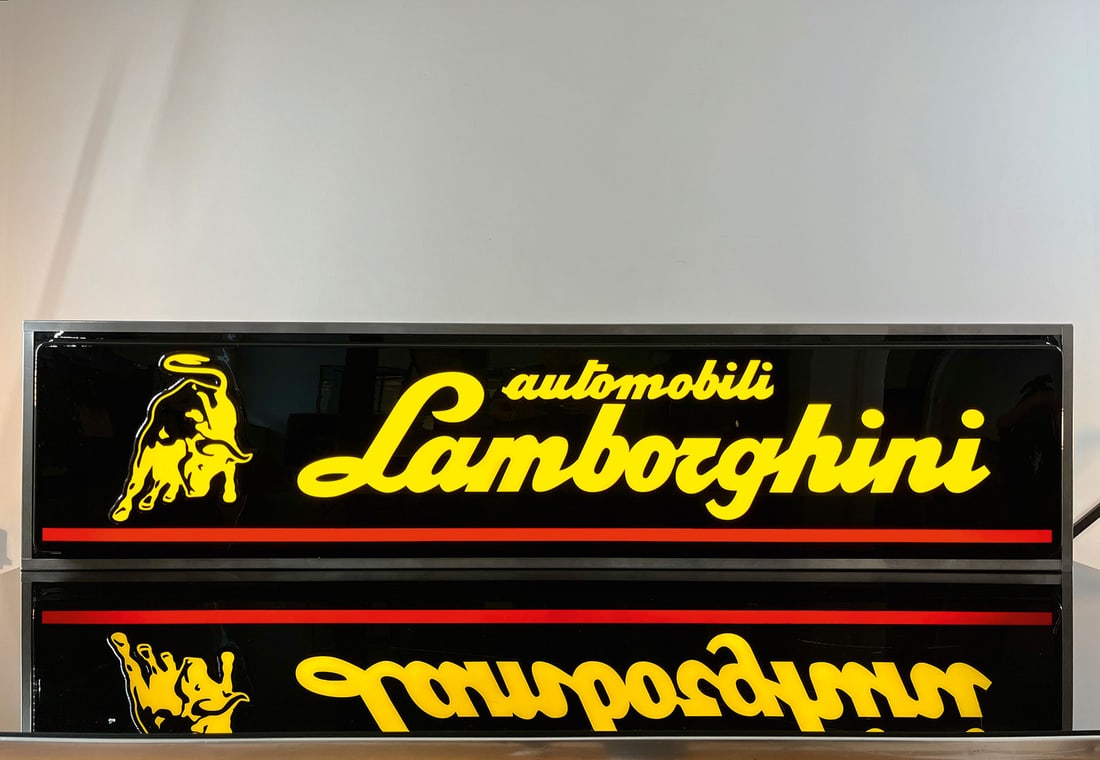 AUTOMOBILI LAMBORGHINI | 75" LIGHTED SIGN | SUPERB CONDITION: Neon sign, metall body, plastic front embossed in relief, IT 1980s, 191 x 46 cm, Serenari Pubblicita, the neon sign for the sports car, only recently discovered in an old warehouse, that's why we like