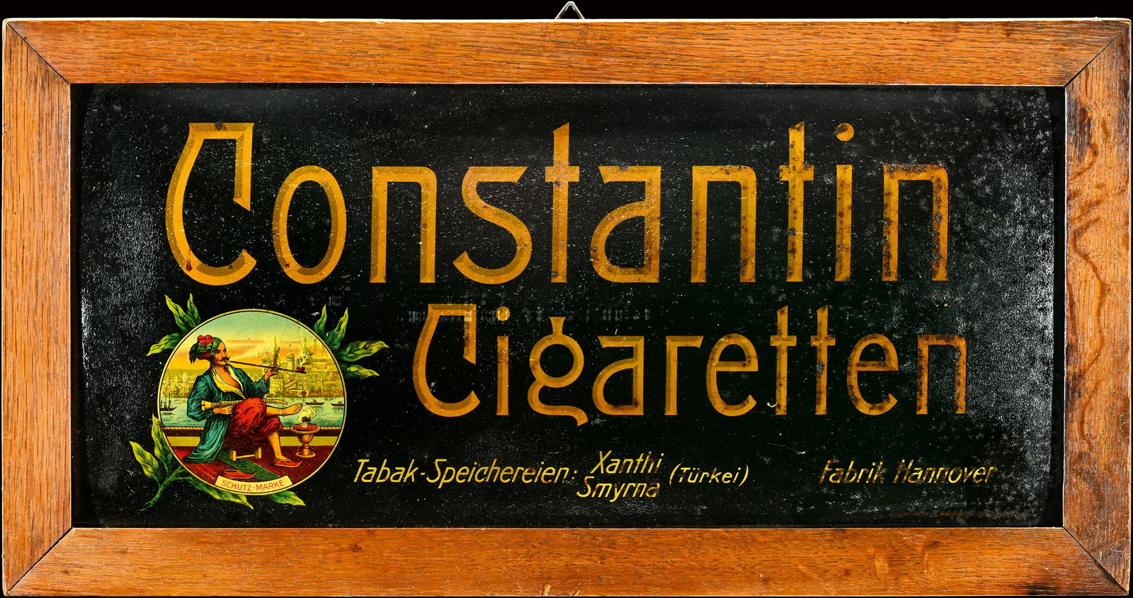 CONSTANTIN CIGARETTEN | TIN SIGN | (2): Tin sign, convex, in original frame, lithographed, GER around 1920, 48 x 25 cm | We do only sell old original pieces - no reproductions or fakes. We pack in house, most items can be shipped overseas. 