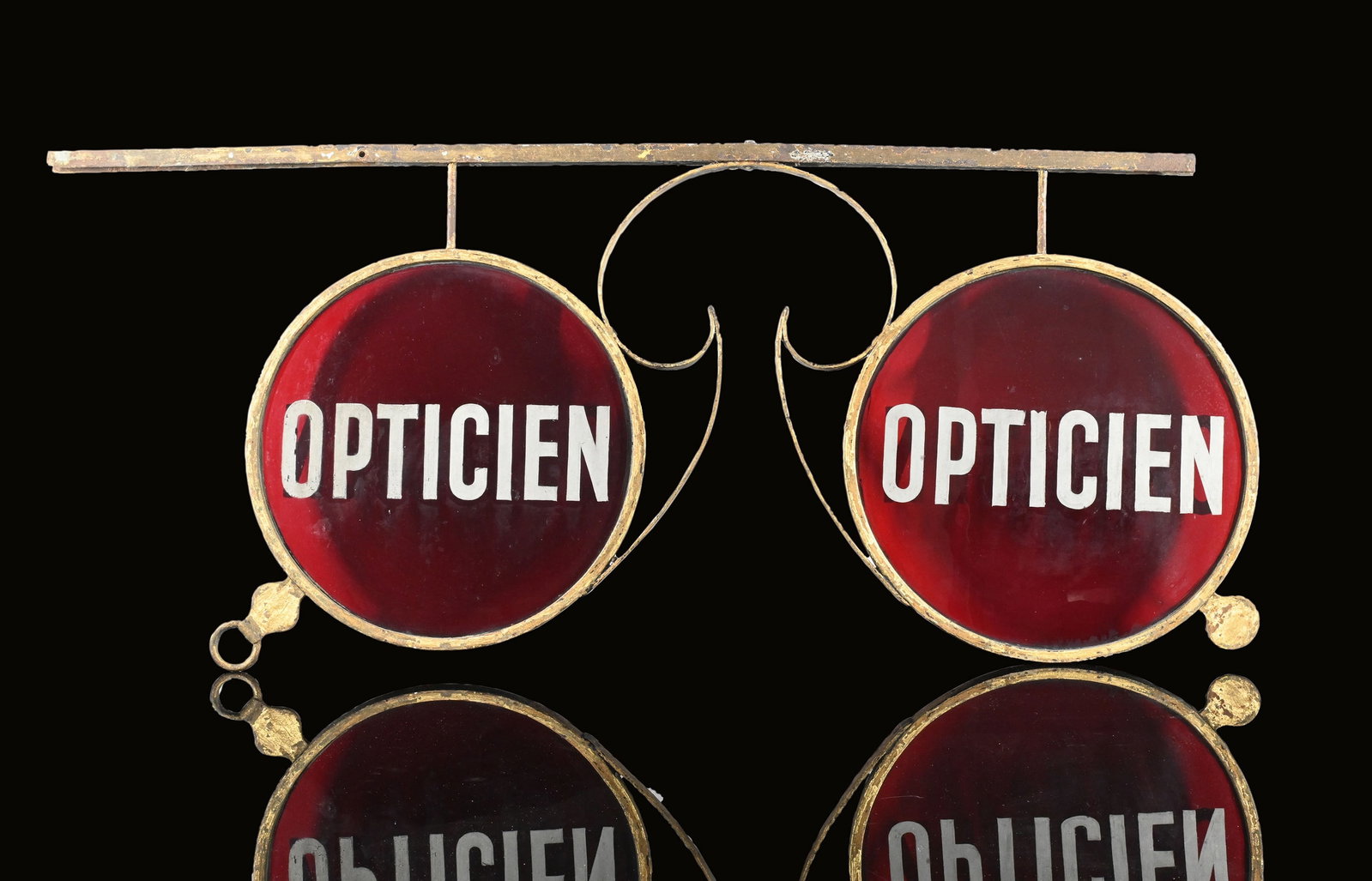 OPTICIEN | ADVERTISING ITEM | (1-2): Outdoor advertisement in the shape of a pair of glasses, flange, metal and glass, F/BE around 1930, 128 x 60 cm, untouched original condition, the hand-colored lettering on the red lenses is in very g