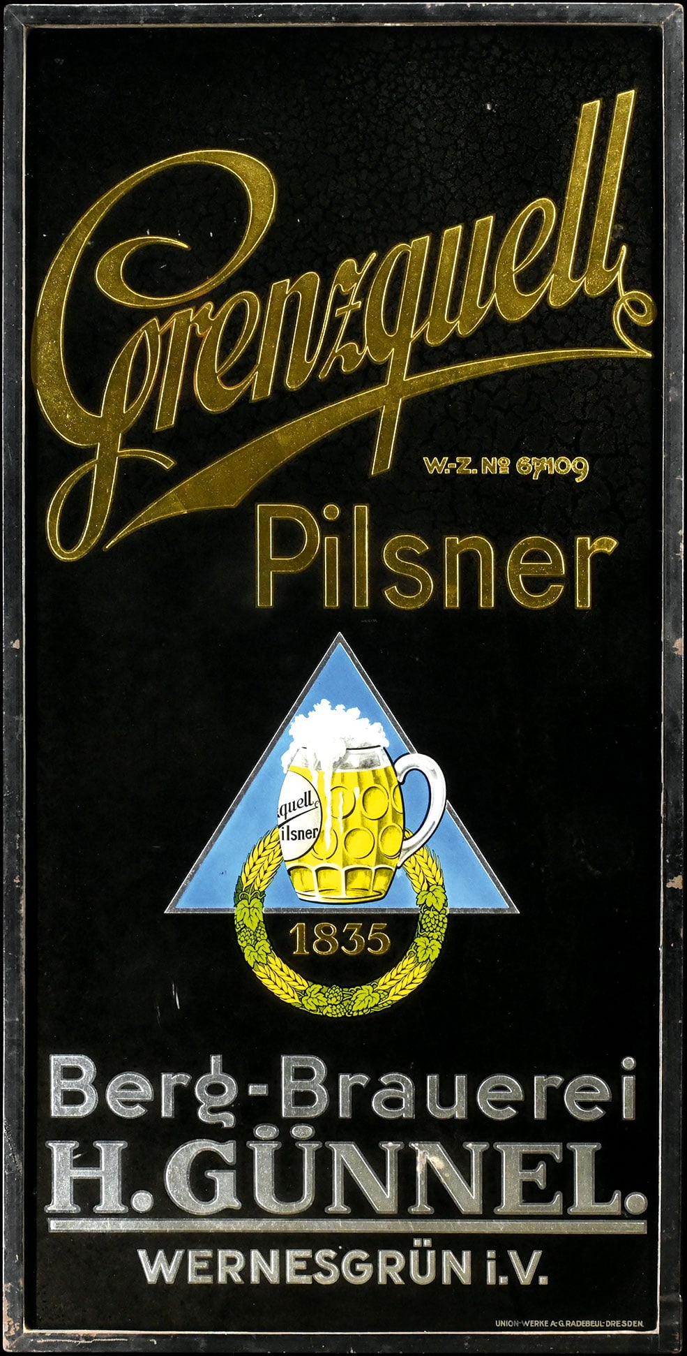 GRENZQUELL PILSNER | GLASS ADVERTISING SIGN | (2+): Reverse-glass lithography, original metal frame, GER 1930s, 50 x 100 cm, Union-Werke A.-G., Radebeul-Dresden, the black with some traces of aging | *Pickup only, delivery is available by prior arrange