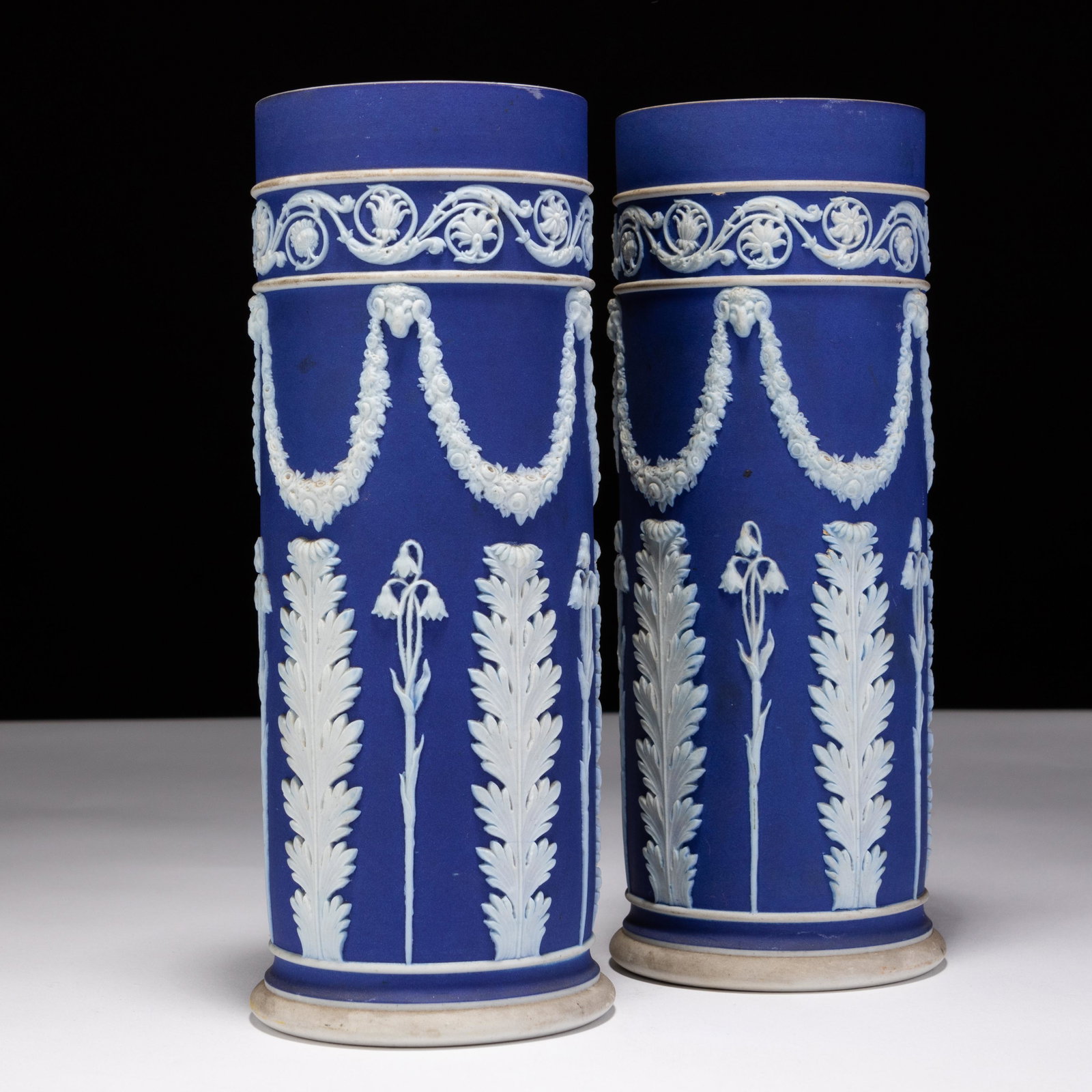 Pair of Wedgwood Dark Blue Jasperware Neoclassical Spill Vases: MEASURES APPROX 19 X 7CM. Please follow us on Instagram to stay updated with our current and future auctions: @albinus_auctions. Study all photographs carefully to get an accurate representation of th