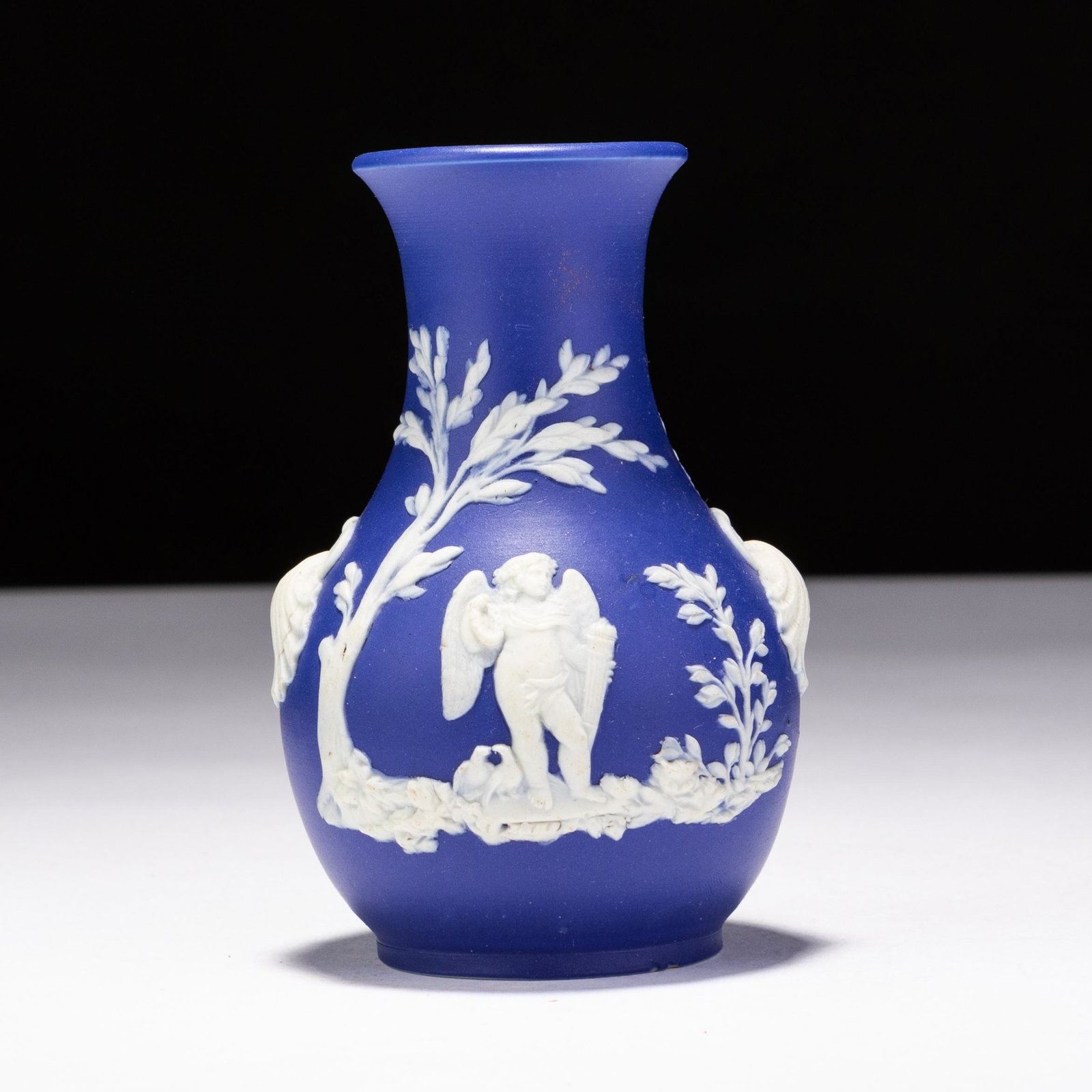 Wedgwood Dark Blue Jasperware Neoclassical Vase: MEASURES APPROX 7 X 10.5CM. Please follow us on Instagram to stay updated with our current and future auctions: @albinus_auctions. Study all photographs carefully to get an accurate representation of