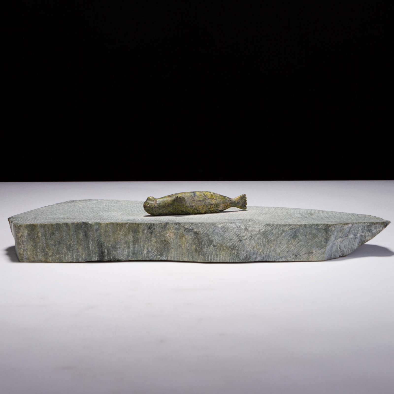 Canadian Inuit Seal Sculpture: MEASURES APPROX 29 X 12 X 5CM. Please follow us on Instagram to stay updated with our current and future auctions: @albinus_auctions. Study all photographs carefully to get an accurate representation 