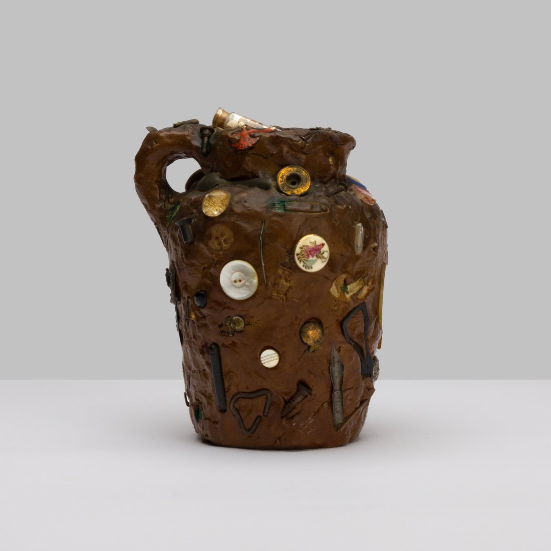 Folk Art, Memory Jug: USA, Early 20th Century clay, objects 6" x 5" x 4" Folk Art memory jug with various embedded objects. key: folk, art, pottery, ceramics, outsider, pitcher