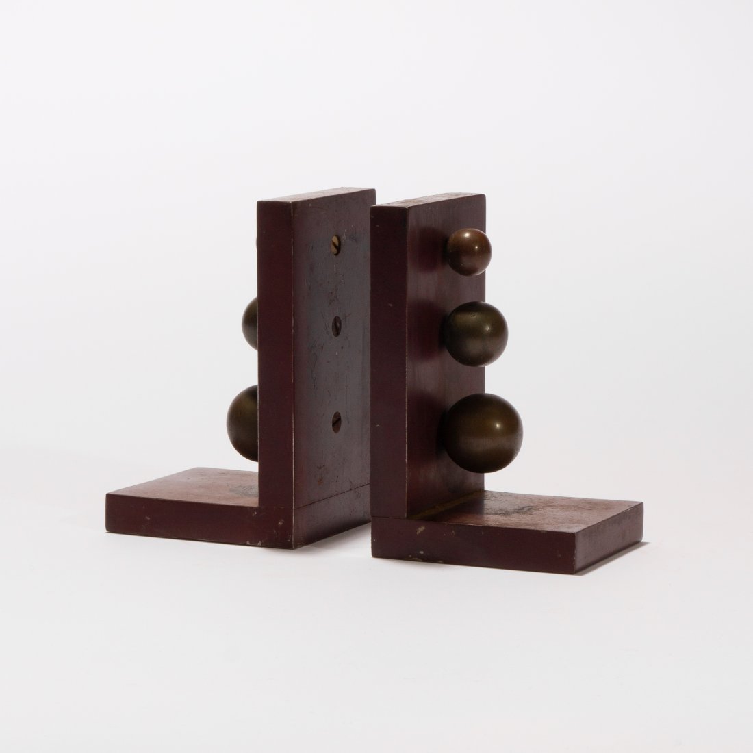 Modernist, Steel and Bronze Bookends: USA, 1930s steel, brass 5.25" x 3.35" x 3" Early modern painted steel bookends with graduating brass balls. key: modernist, deco, moderne, machine age