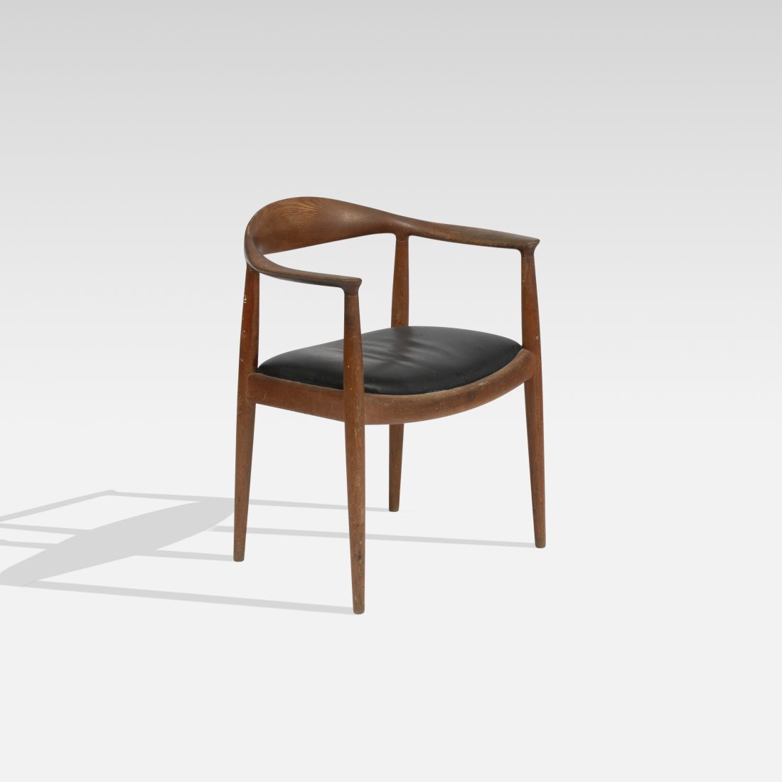 Hans Wegner, The Chair: Denmark, 1950s teak, leather, 24 1/2" x 20" x 30" x 18" seat The Chair by Hans Wegner for Johannes Hansen. Manufacturerâ€™s mark to underside [JOHANNES HANSEN COPENHAGEN DENMARK]. Tags: modernist