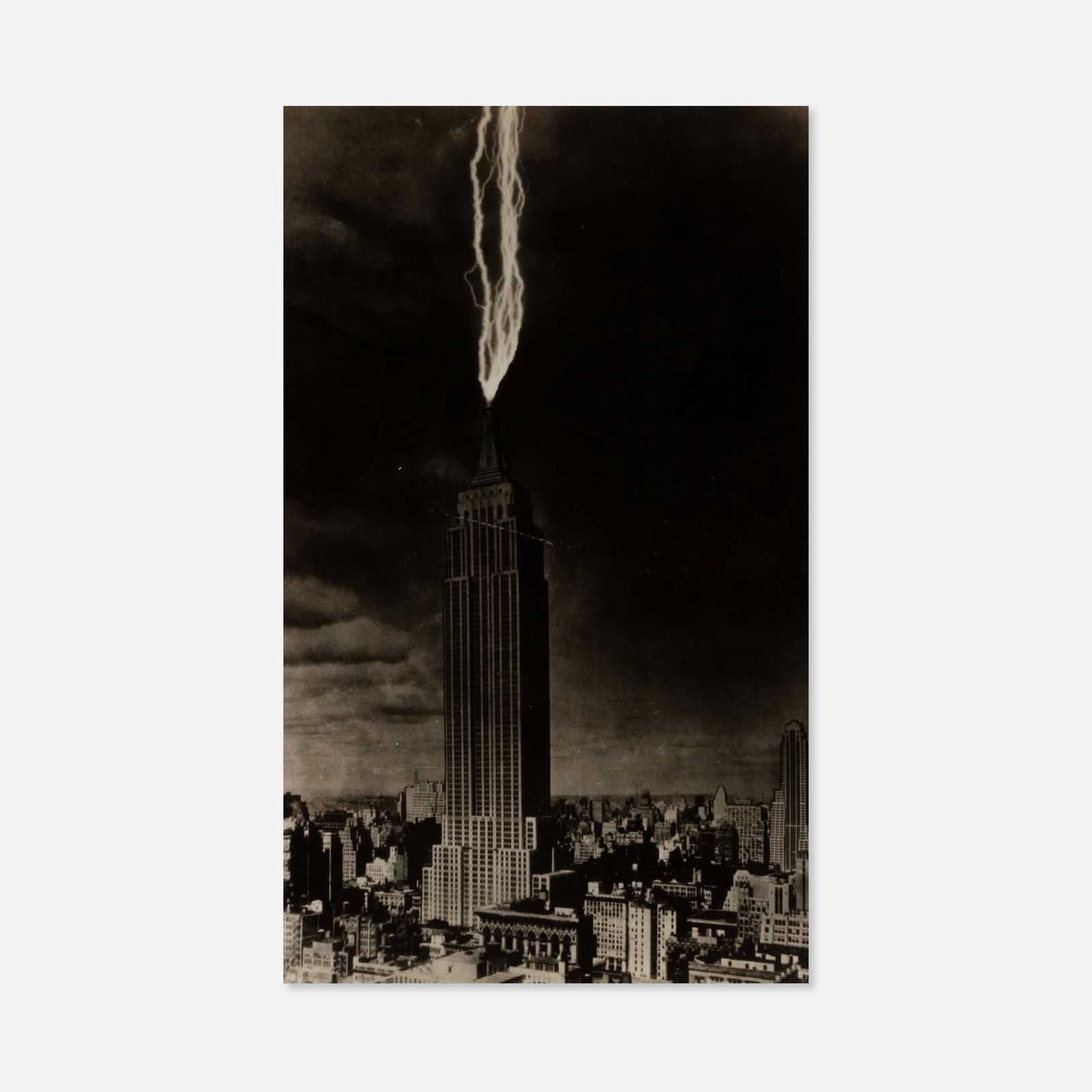 Trick Photograph, Empire State Building Lightning: USA, c. 1930s 10 1/8" x 8" vintage silver print Composite photograph of lightning striking the Empire State Building. This item is located in our Treadwell, NY warehouse. Pickup and shipping