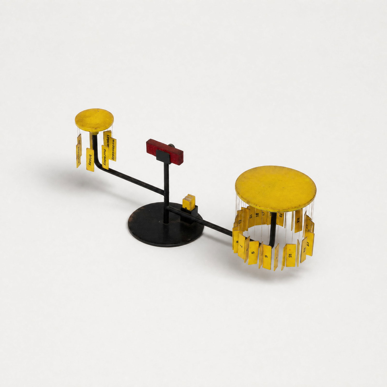 Paolo Tilche, Tite Perpetual Calendar: Italy, 1957–1959 5" x 12 1/2" x 3 1/2" enameled steel, printed paper, magnet, and string Magnetic perpetual table calendar having a central structural magnet and suspension cords to secure printed