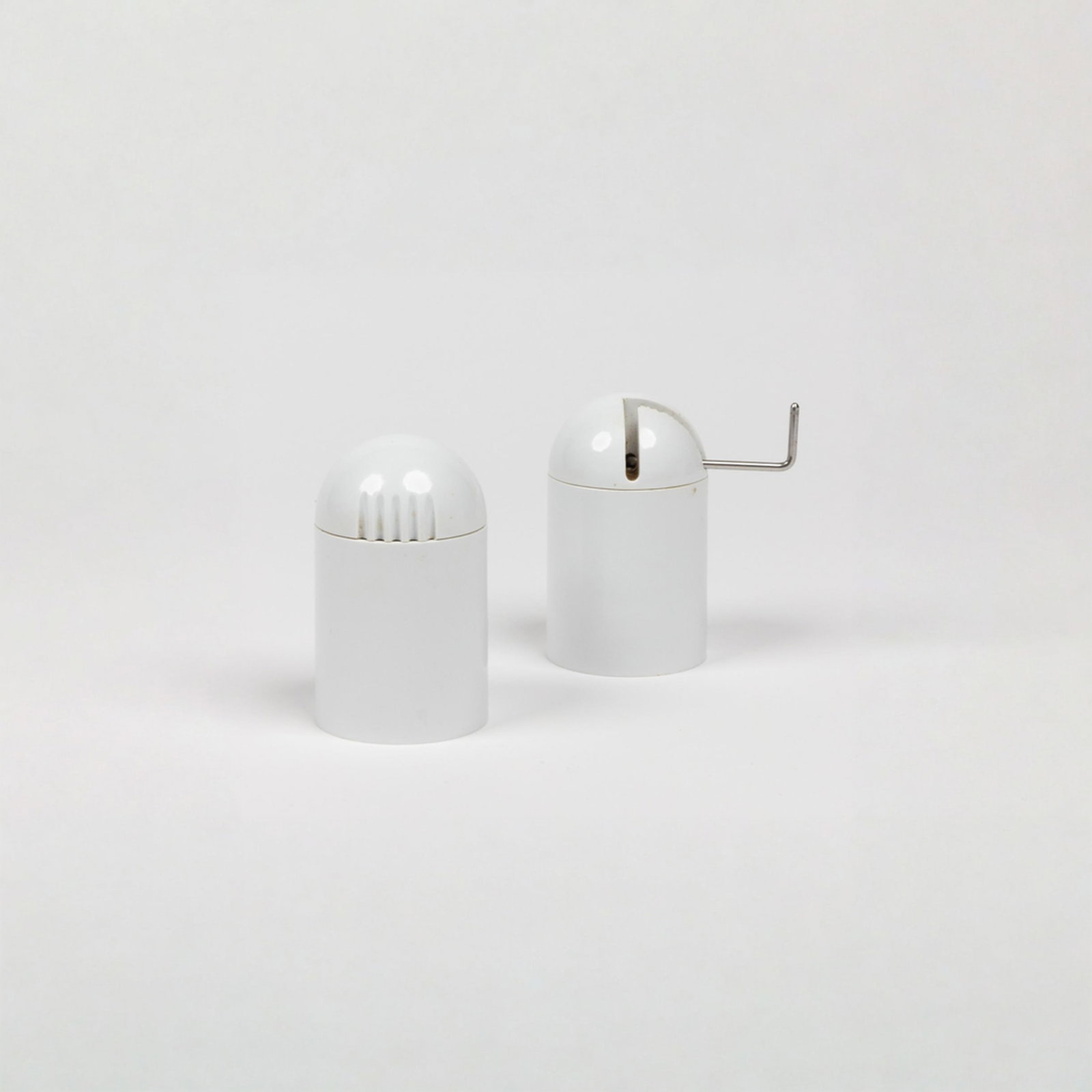 Enzo Mari, Model 3098, Salt and Pepper Mill: Italy, 1972 3 1/2" x 2 1/8" molded melamine and steel Molded melamine and steel salt shaker and pepper mill set from the Faraglioni (Model 3098 A) series, designed in 1972 and manufactured by Danese