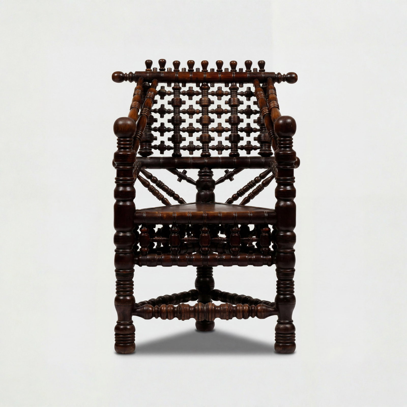 Elizabethan Revival, Thrown Chair: England, 19th Century 36 1/2" x 25" x 20" turned oak Three-cornered "thrown" armchair featuring an an asymmetrical three-legged frame, a form which developed prominently throughout sixteenth and