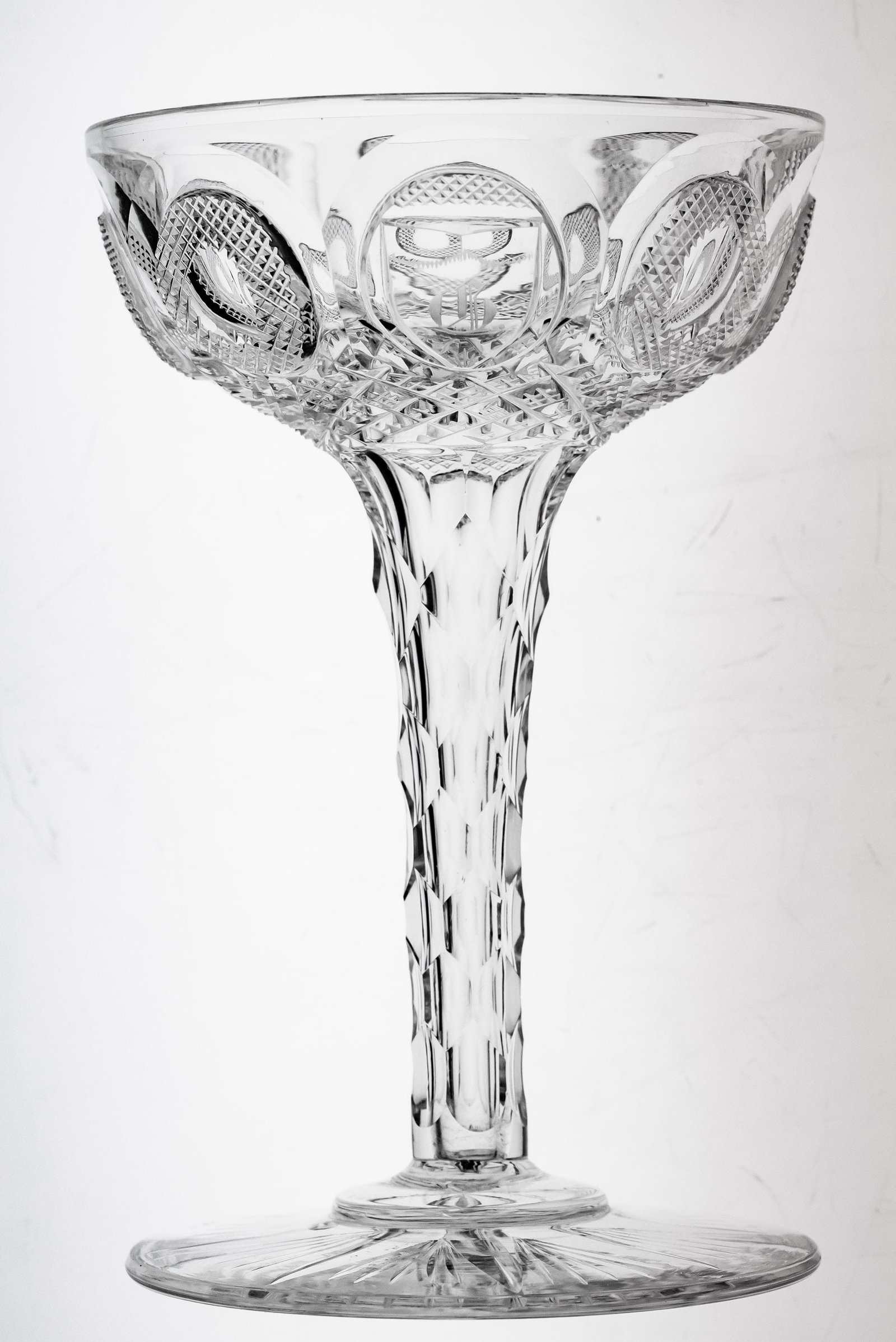 Seldom Seen Dorflinger Buckle American Brilliant Period Cut Glass Hollow Champagne: This hollow stem champagne was cut by Dorflinger in their early Buckle design. It features an entirely hollow stem cut in their hollow-diamond cutting and a Brooklyn star base. Monogrammed with a "G" 