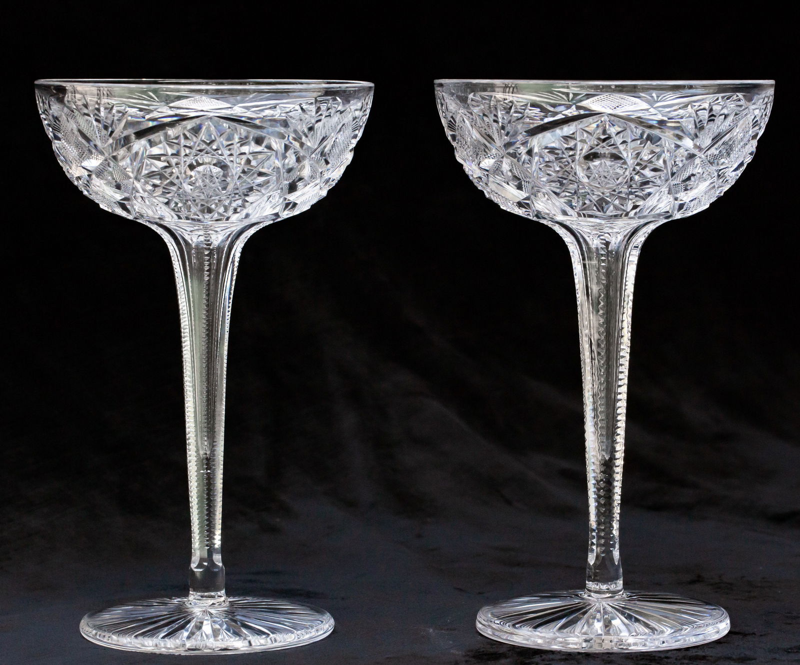 Unusual Pair of Libbey American Brilliant Cut Glass Hollow Stem Champagnes: This is a very unusual pair of extra tall, hollow stem champagnes both signed Libbey in their Venetia pattern. They also feature an unusual rayed star on the base.