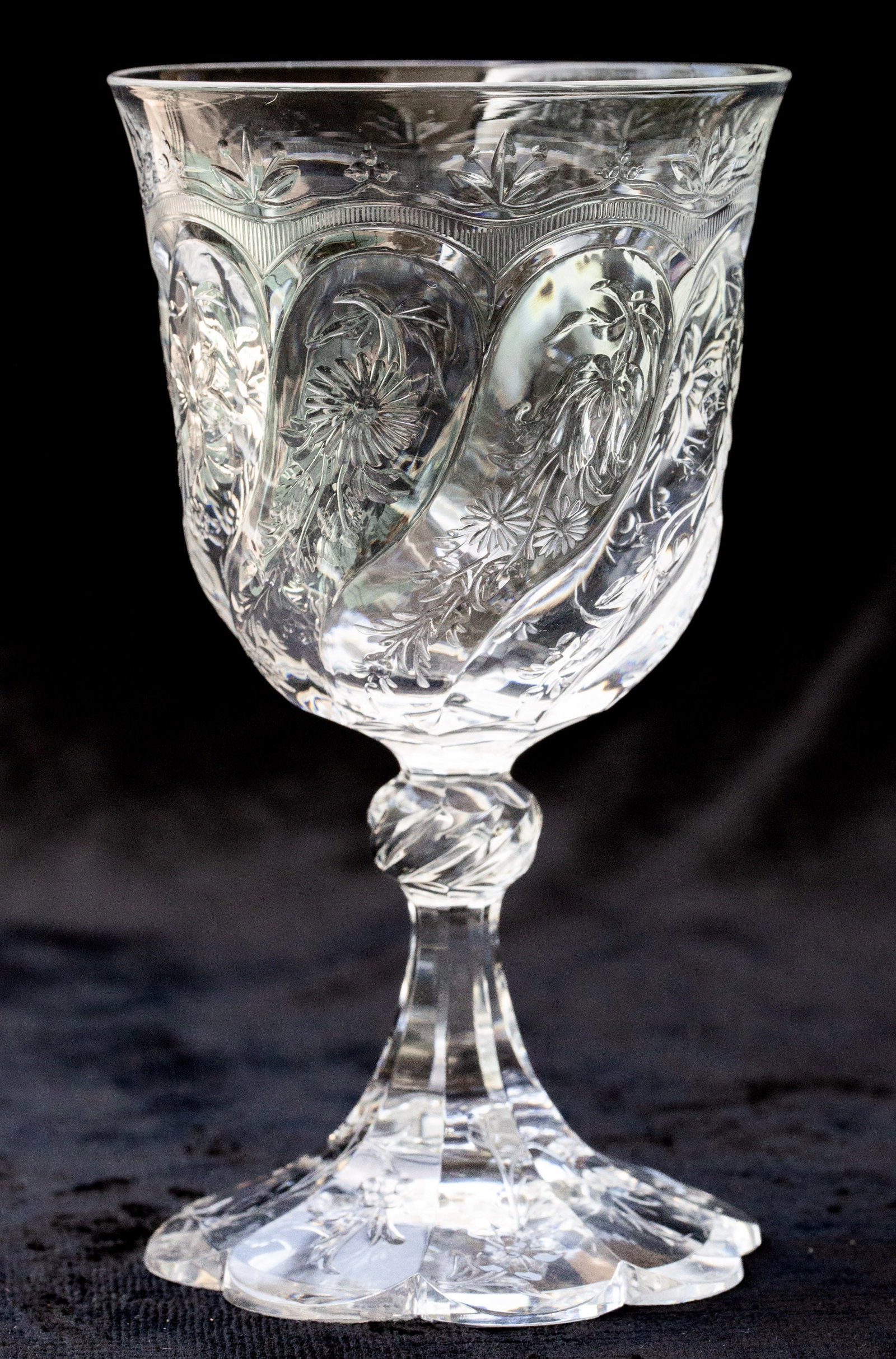 Fabulous Stevens & Williams Brilliant Cut Glass Rock Crystal Engraved Wine Glass: This is unbelievably high quality wine by Stevens & Williams. It's engraved upon swirling panels in rock crystal style with different flowers on nearly every panel. The shape of the wine is special as