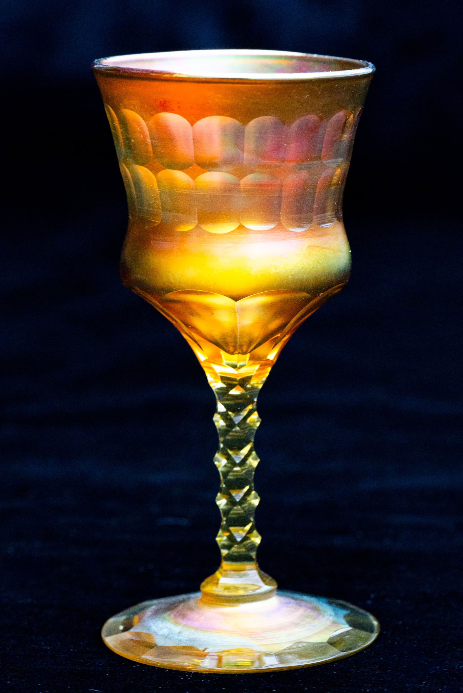 Rare Tiffany Favrille American Brilliant Period Cut Glass Gold Wine Stem: This is an incredibly rare example of Tiffany Favrille stemware. While it has the traditional technique and coloring of Favrille, it also has brilliant period cutting on the stem, neck and bowl of the