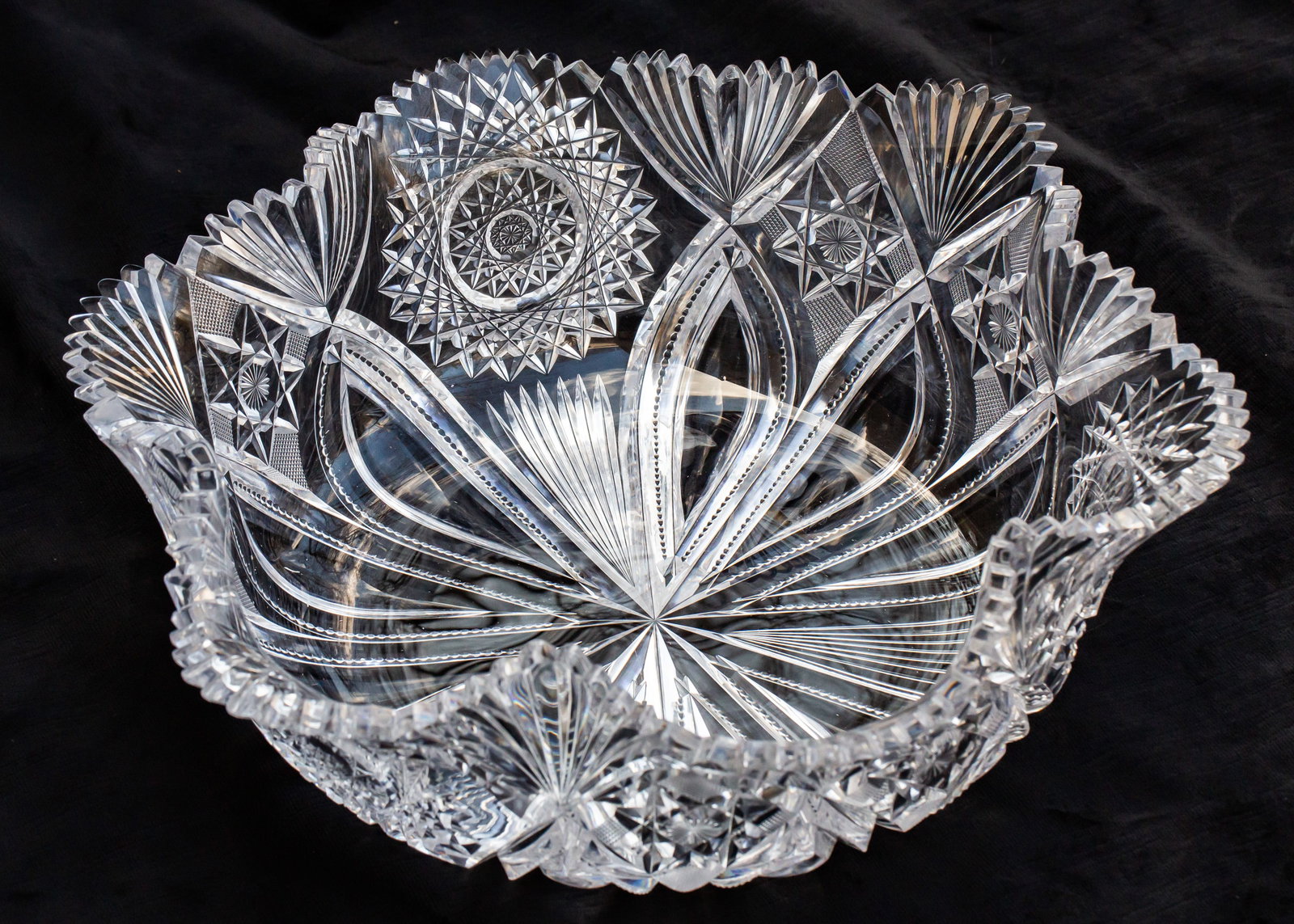 Huge Straus Ducal American Brilliant Period Cut Glass Crimped Bowl: This is a gigantic bowl cut in Straus's tusk-laden Ducal design. The pattern is quite elegant featuring large hobstars on the ends interspersed with notching, 8 pointed hobstars with crosshatched fill