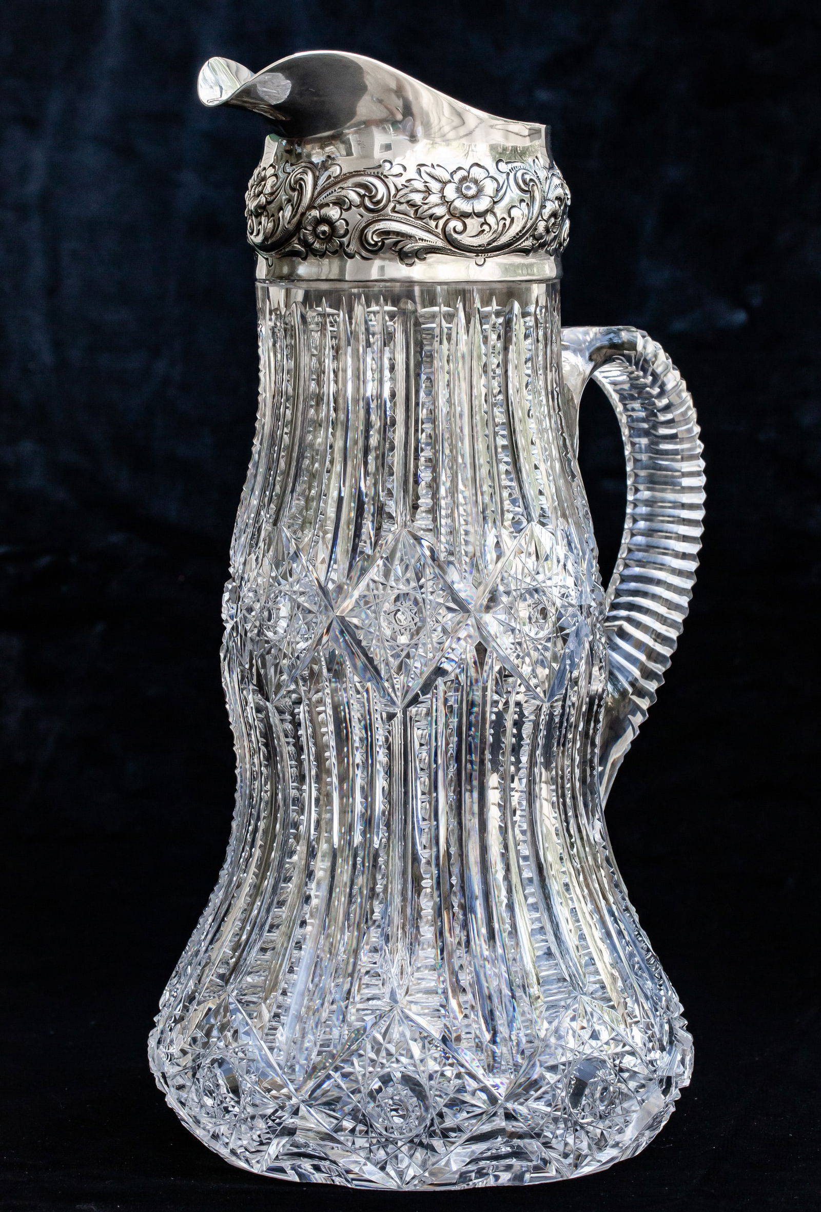 Exceptional Dorflinger Victor American Brilliant Cut Glass Dominick & Haff Sterling Silver Pitcher: This is an exceptional and unusually shaped pitcher by Dorflinger in their seldom-seen Victor design. The pattern adapts itself quite well to this form that bulges at both the middle and the bottom -