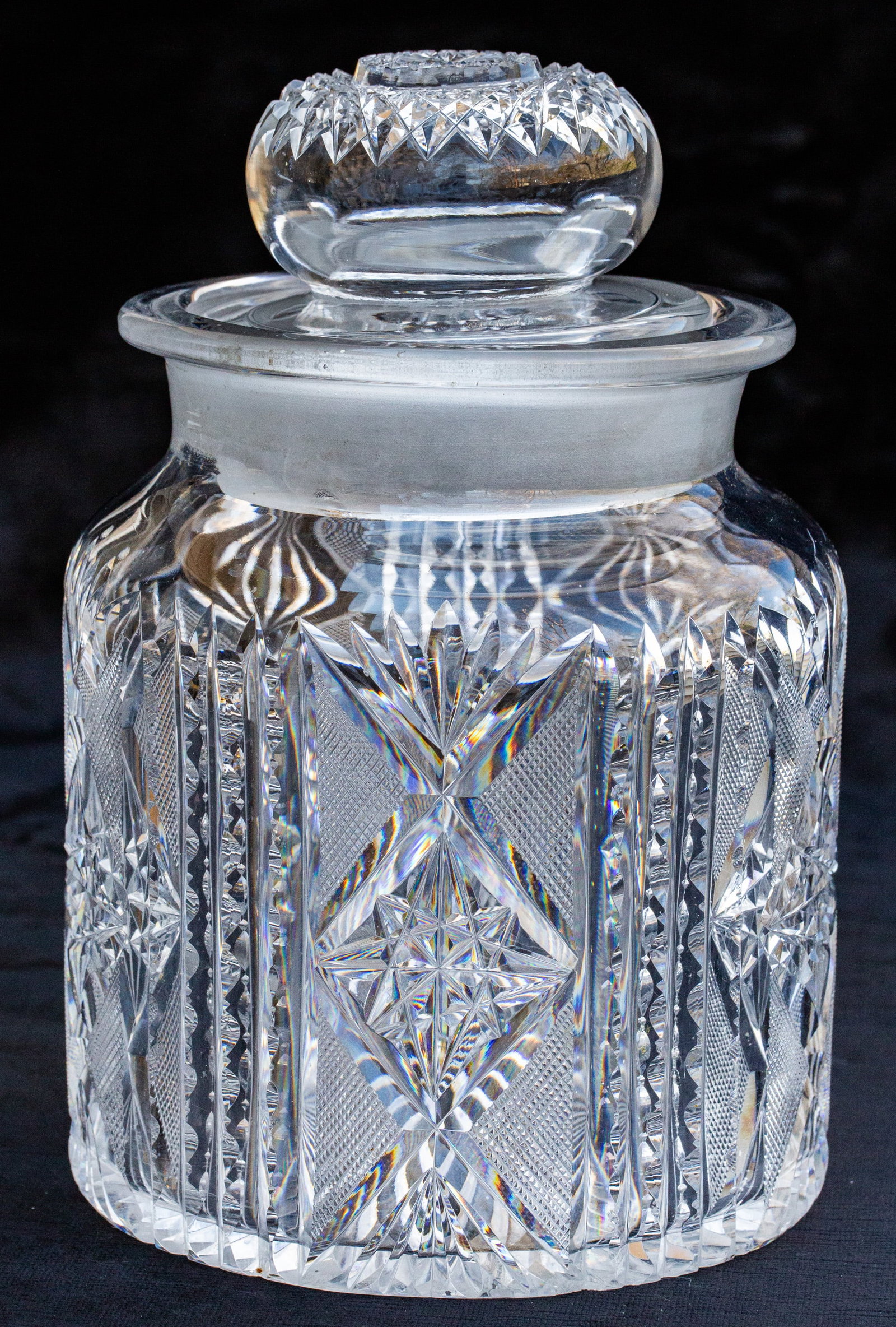 Beautiful Large Monroe? American Brilliant Cut Glass Humidor Cigar Jar: Very large humidor cut in a design with notching, flat hobstars, and crosshatching. Top features a deeply cut hobstar and base is also covered with a rayed star. Pattern looks like Ariel by Monroe.