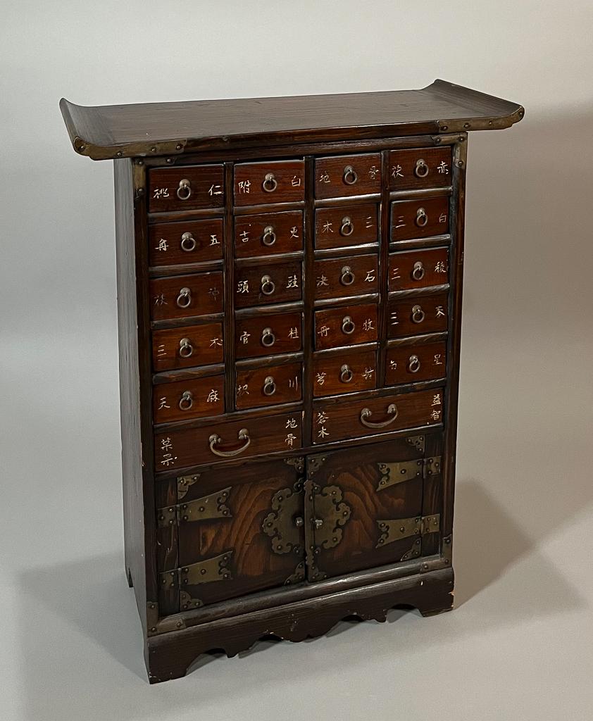 Vintage Chinese Apothecary Cabinet: Vintage diminutive Chinese apothecary cabinet; scroll-style top, 22 drawers with lower two-door compartment; 27" x 21" x 9" (approx.)