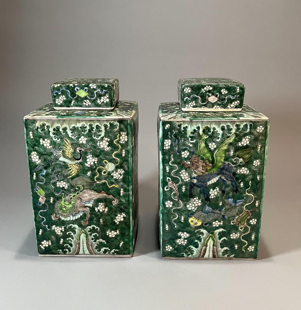 Pair of Chinese Famille Verte Square-Form Covered Containers: Pair of Chinese famille verte square-form covered containers; each with qilin, crane, fish and phoenix within a foliate design; 12 1/2 x 7 1/4" sq. (each, approx.)