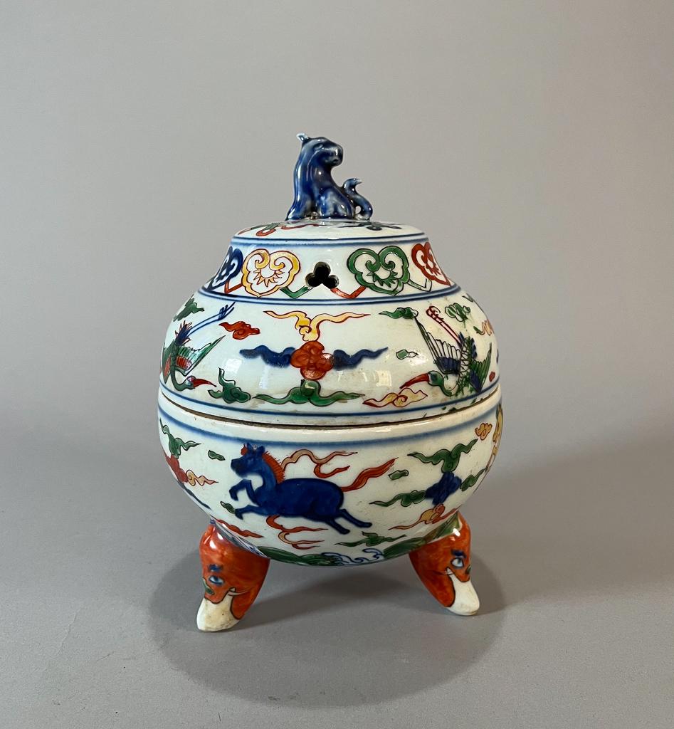 Chinese Wucai Porcelain Covered Censer: Chinese wucai porcelain covered tripod censer; with beast-face form feet, animal-form finial; decorated with horses, cranes and clouds, with six-character mark to base; H: 8" (approx.)