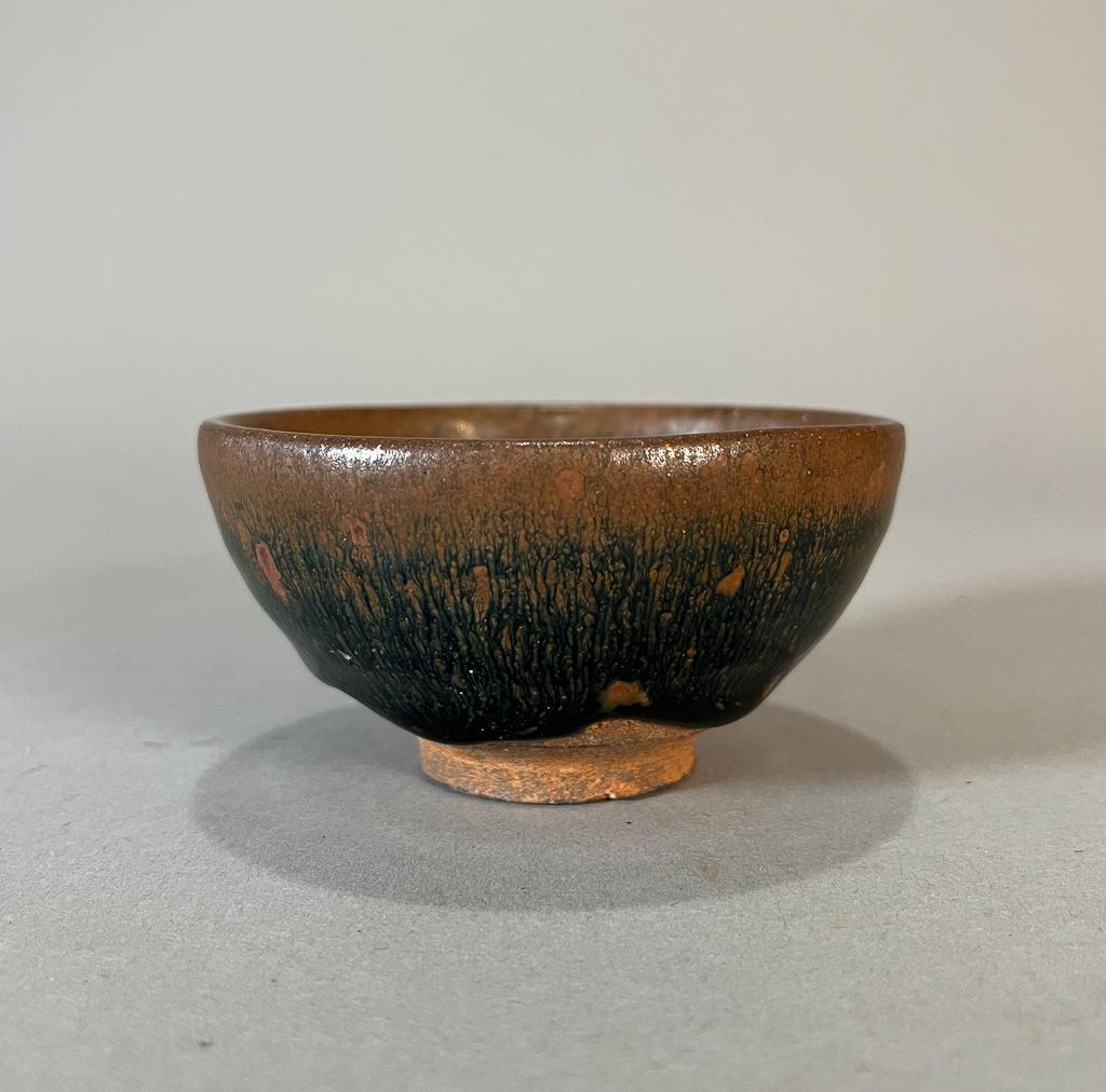 Chinese Hare's Fur Tea Cup: Chinese hare's fur tea cup; with black and brown streaking glaze, of tapering form with recessed foot; 1 3/4" x 3 1/2" (approx.)