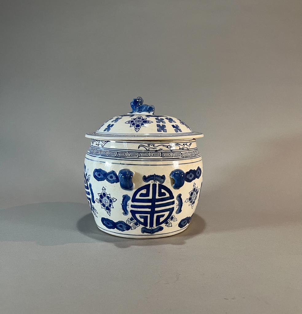 Chinese Blue & White Porcelain Covered Jar: Chinese blue & white porcelain covered jar; with pierced molds to shoulder and animal-form finial; depicting shou characters, bats motif and geometric key pattern to body and lid; 8 1/2" x 8 1/2" (app