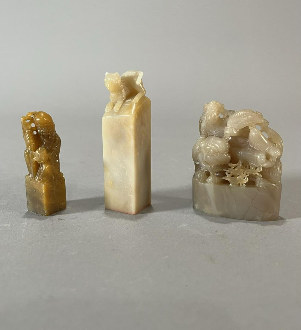 Group of Three Chinese Soapstone Seals: Three Chinese soapstone seals; including a cat with mark; an unmarked Shoulou and an unmarked scholar lying upon a fu dog; 3 1/4" x 3/4" sq. (tallest, approx.)