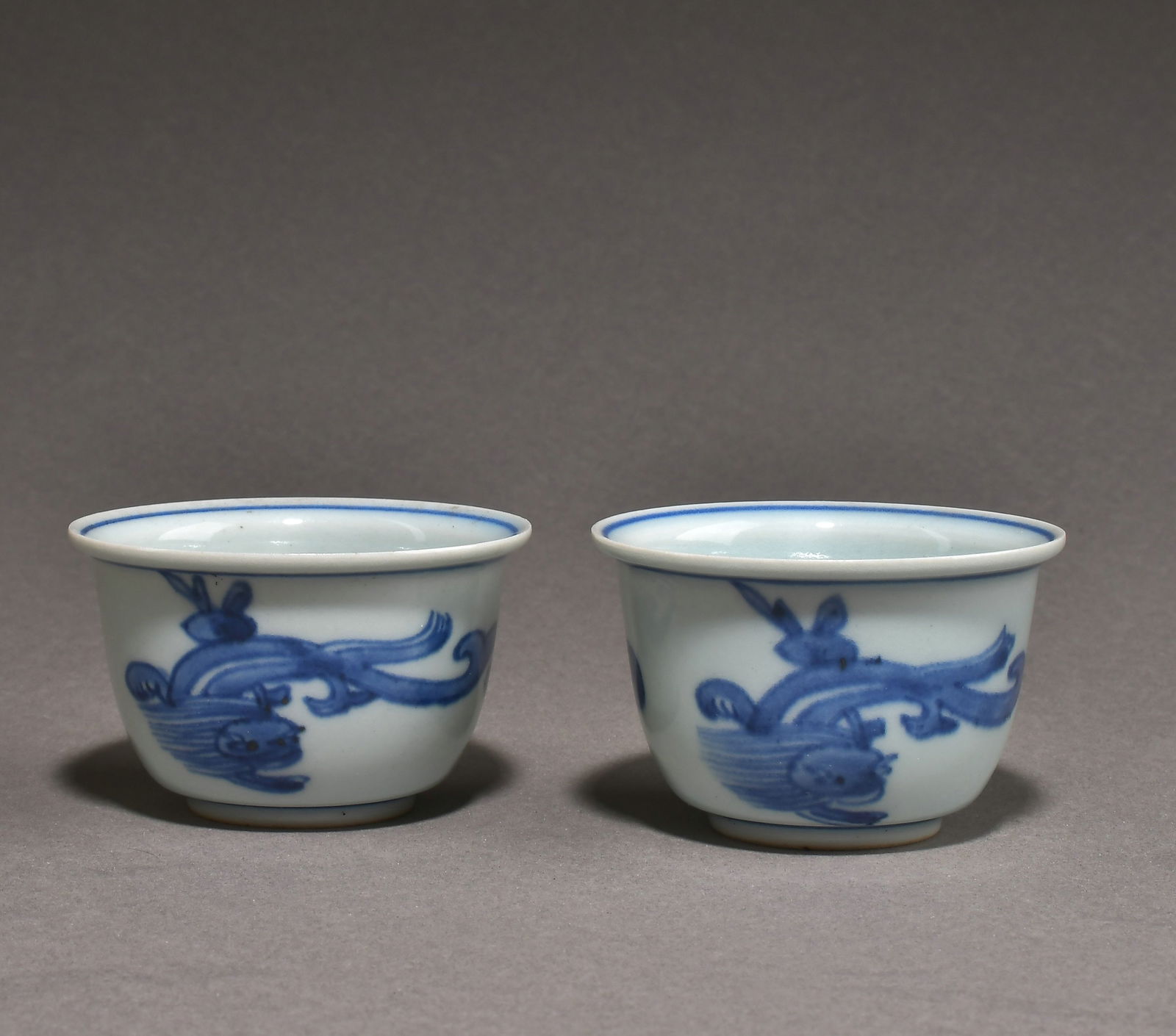 A pair of blue and white cups: Height 5cm Width 7.5cm