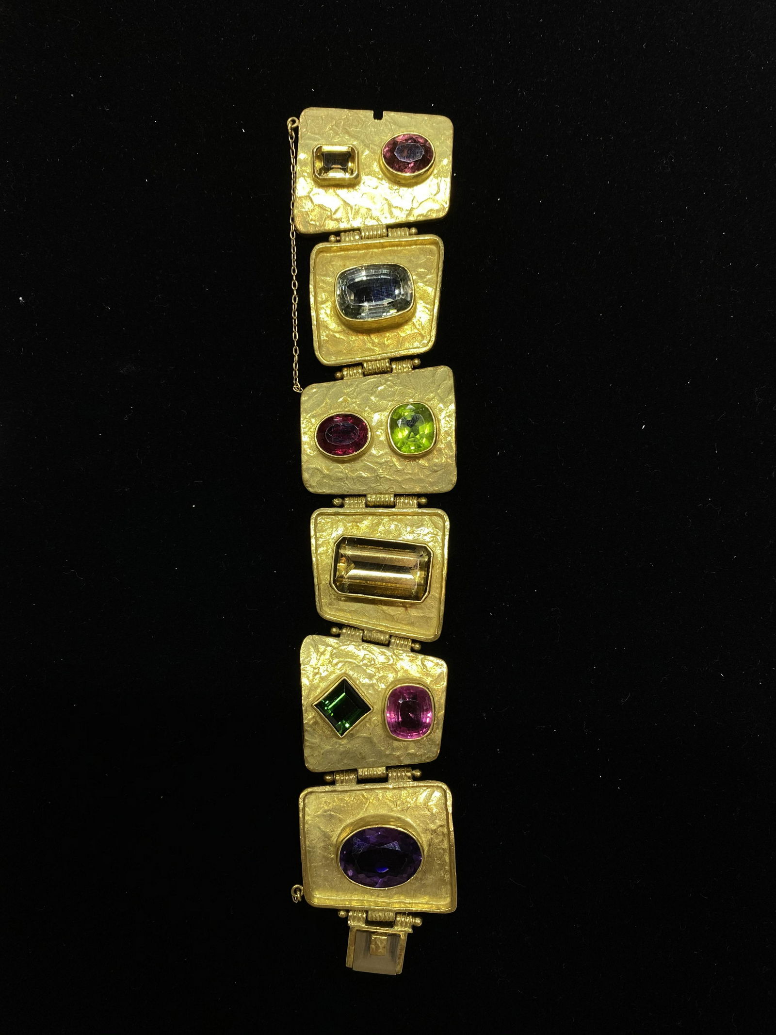 ED WEINER 1980's Textured 18K Yellow Gold Bracelet with: The joy of wearing a piece of art is within reach when you grab this stunning Ed Wiener Bracelet! The bracelet is crafted entirely from precious 18K Yellow Gold with Multi-Colored Stones. There's Pink