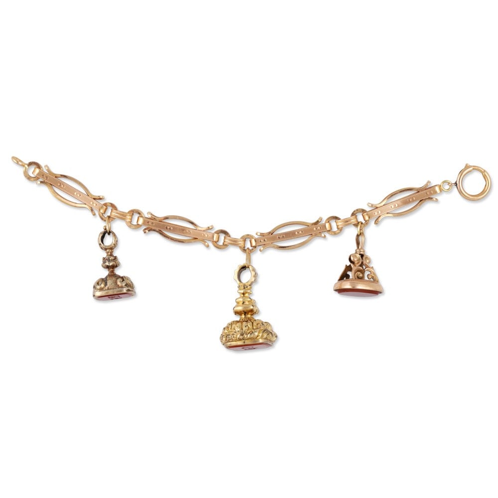 9KT GOLD BRACELET SET WITH THREE CARNELIAN SEALS ENGRAVED WITH MONOGRAMS, TWO MOUNTED IN GILT METAL: Total gross weight gr. 38 Length approx. 19,5 cm