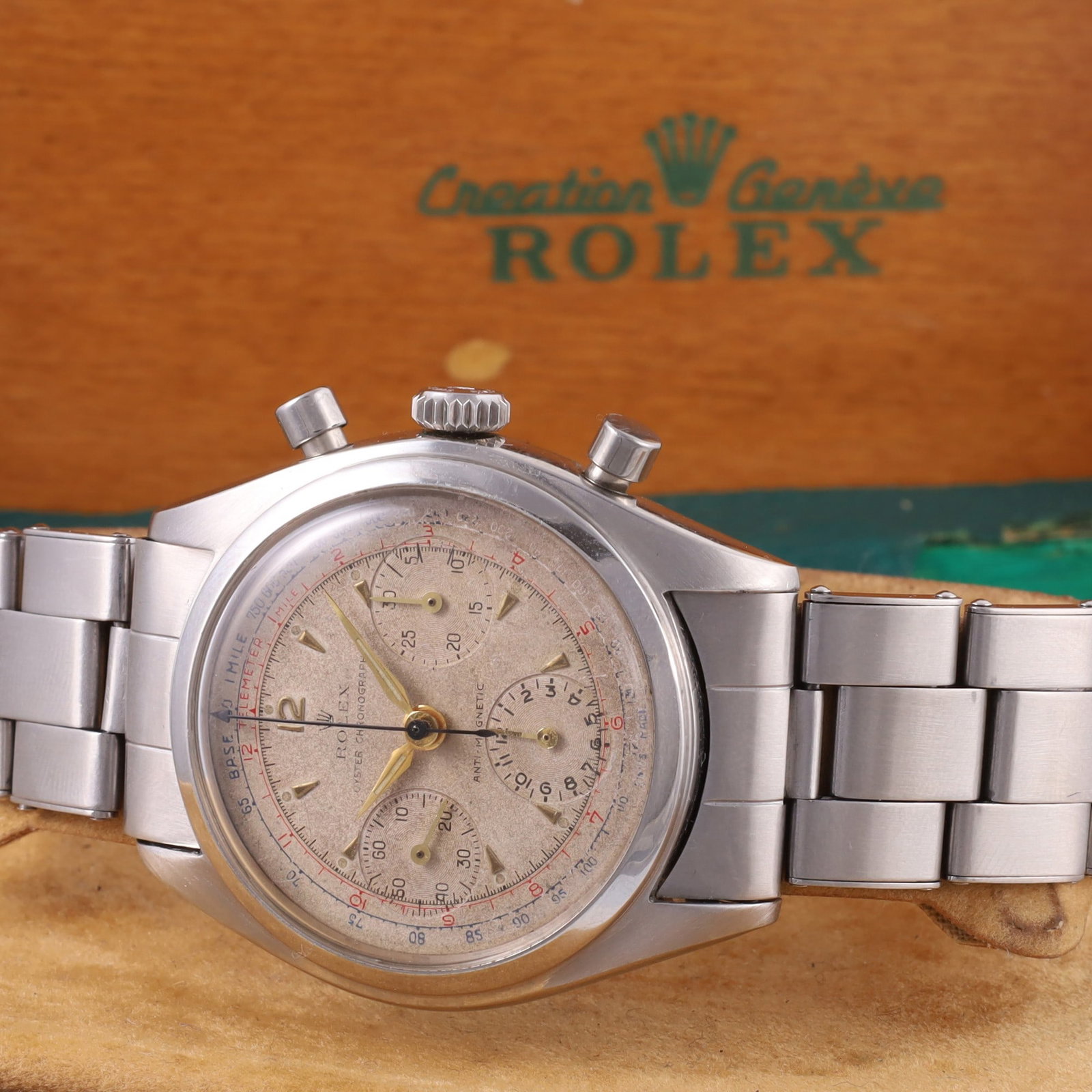 Rolex: Rolex Ref: 6034 Fine and rare, stainless steel chronograph wristwatch with cream coloured dial, multi-scale, applied indexes, Alpha hands and Rolex riveted bracelet Ref. 7205 with deployant clasp