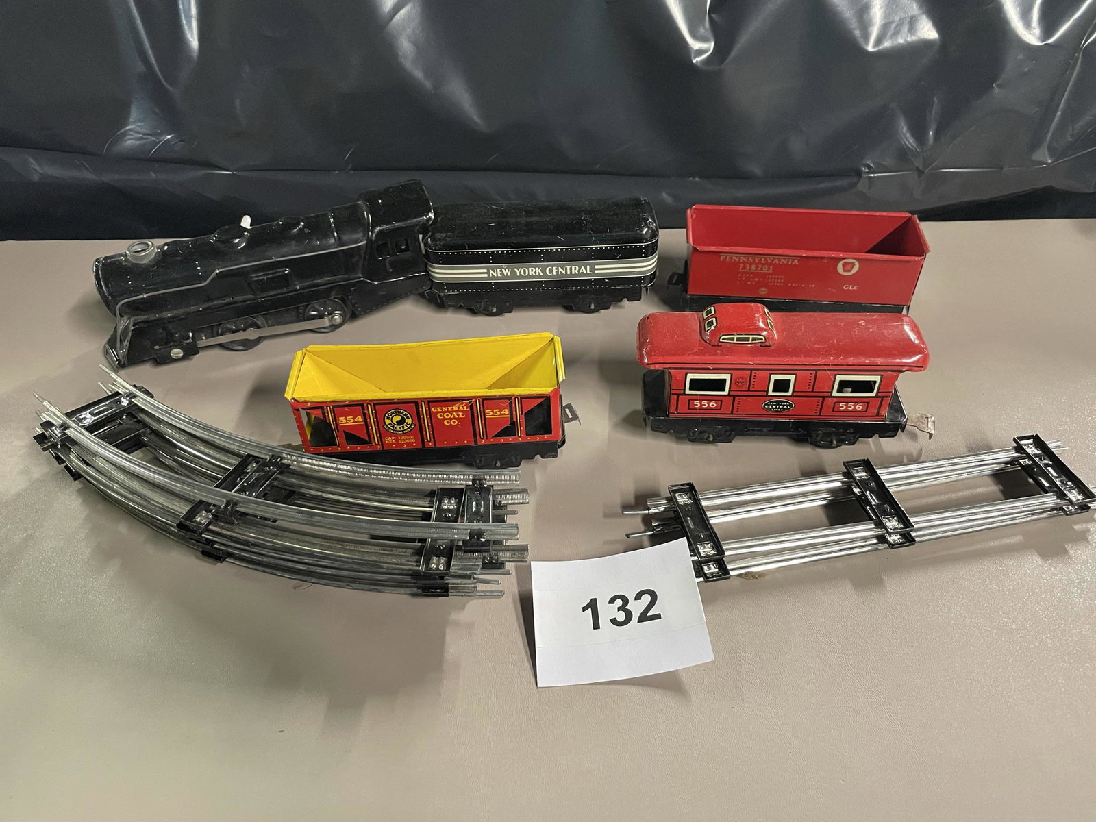 Marx New York Central Line train with tracks: Engine, tender. Pennsylvania, Northern Pacific coal cars and Caboose. Shipping is available.