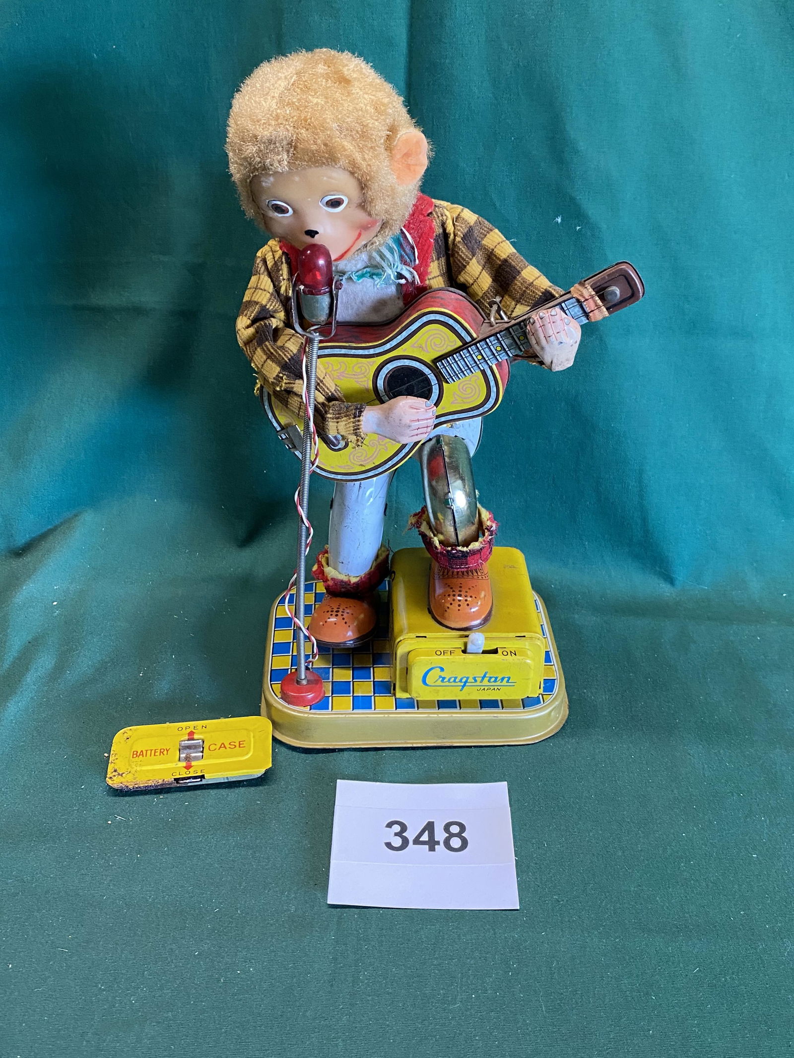 Battery operated Craqstan Rockin Roll Monkey.: Monkey play a guitar. Clothing has been nibbled by a mouse. Shipping is available.