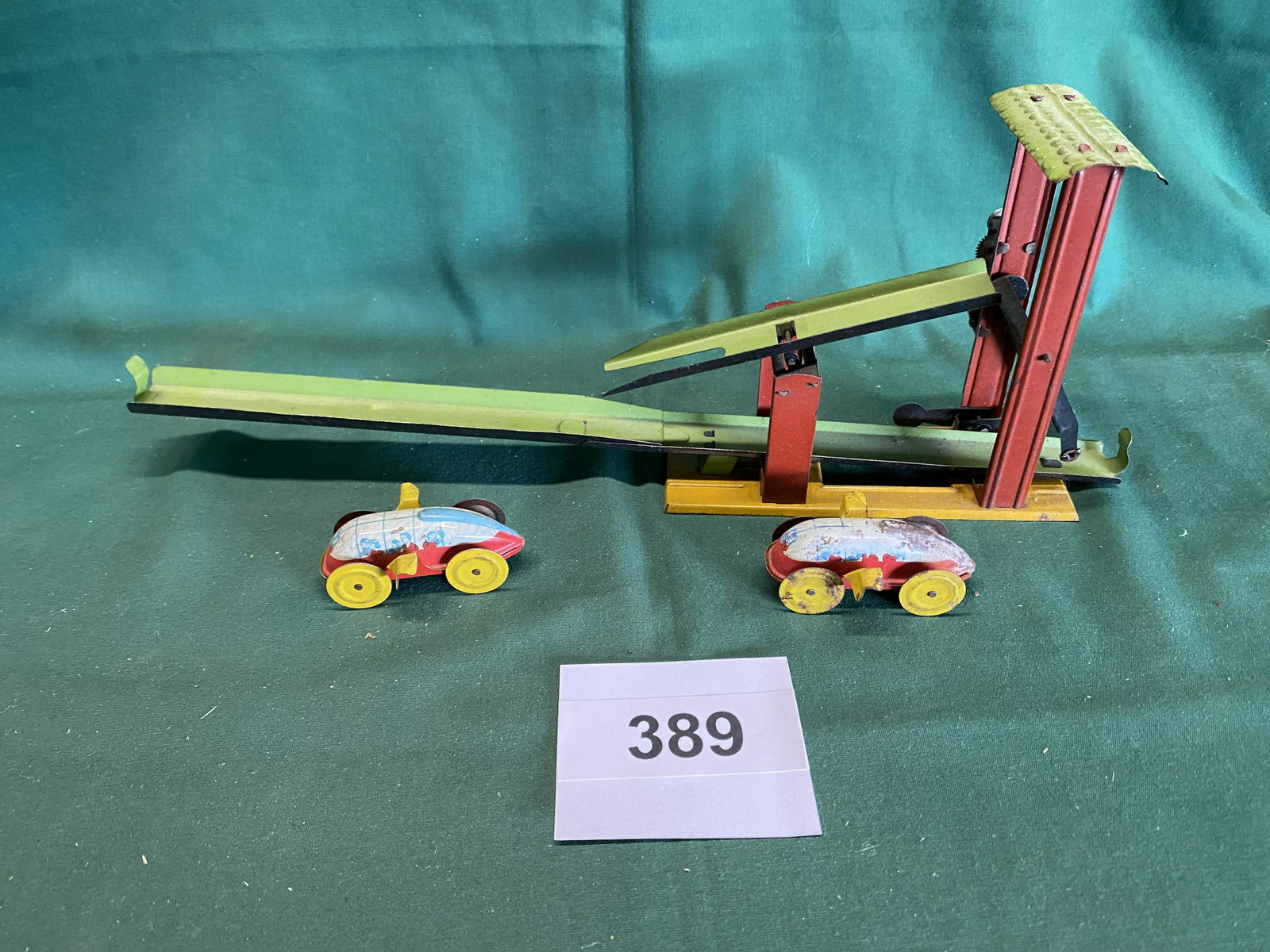 1930's tin wind up toy with 2 cars: Cars not correct for toy wind up mechanism works. Shipping is available.