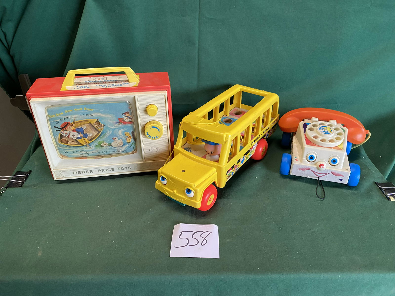 3 Fisher-Price toys: Giant Screen Music Box TV. One sticker has a piece missing but everything else is in good condition. School bus. Wood bottom. Graphics are in ok shape. Pull along phone. Graphics are good but two have