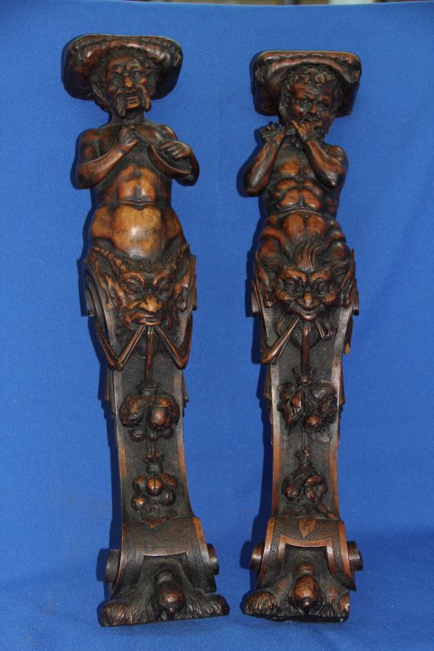 Pair of Carved Wood Figural Sconces: Pair of carved wood figural sconces. One has a broken piece of wood close to the mouth area. Measures 19 1/2 inches.