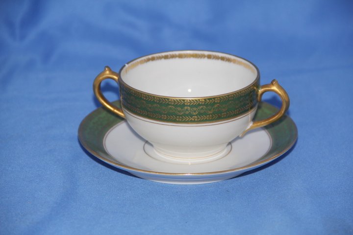 Porcelain Bouillon Cup: Porcelain bouillon cup. Green with gold decoration. Saucer measures 5 1/2 in. diameter and cup measures 3 3/4 in. diameter.