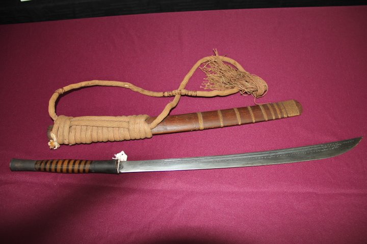 Fullered Blade with Elongated Point 20 1/2 in.: 221-904 Fullered blade with elongated point. 20 1/2 in. Brass grip with rattan wrapped scabbard.