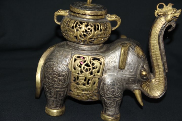Gilt Silver & Gold Elephant Incense Burner: 96-1338 19th Century gilt silver and gold elephant incense burner. The nose of the elephant is a dragon. Decorated with a variety of patterns. Measures 4 1/2 in. x 10 3/4 in. x 10 in.