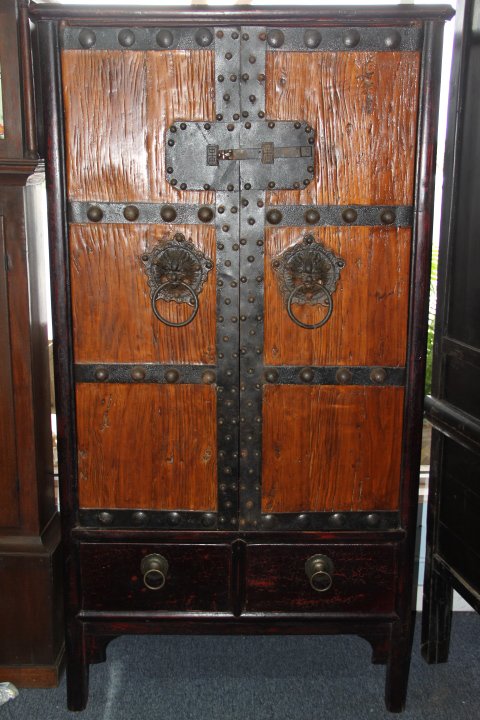Antique Chinese Armoire: 196-1791 Antique Chinese armoire. Circa 1850s. From the Shan Xi Province of China. Large lion head handles on the front. Made of elm wood. Measures 74 in. tall x 39 in. wide and 23 in. deep.