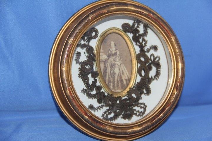 Victorian Mourning Hair Wreath: 5-7943 Victorian mourning hair wreath in shadow box frame. Year of birth and passing on the back, 1820-1866 with additional provenance. Photo of a lady with detailed work around the photo. Measures 6 